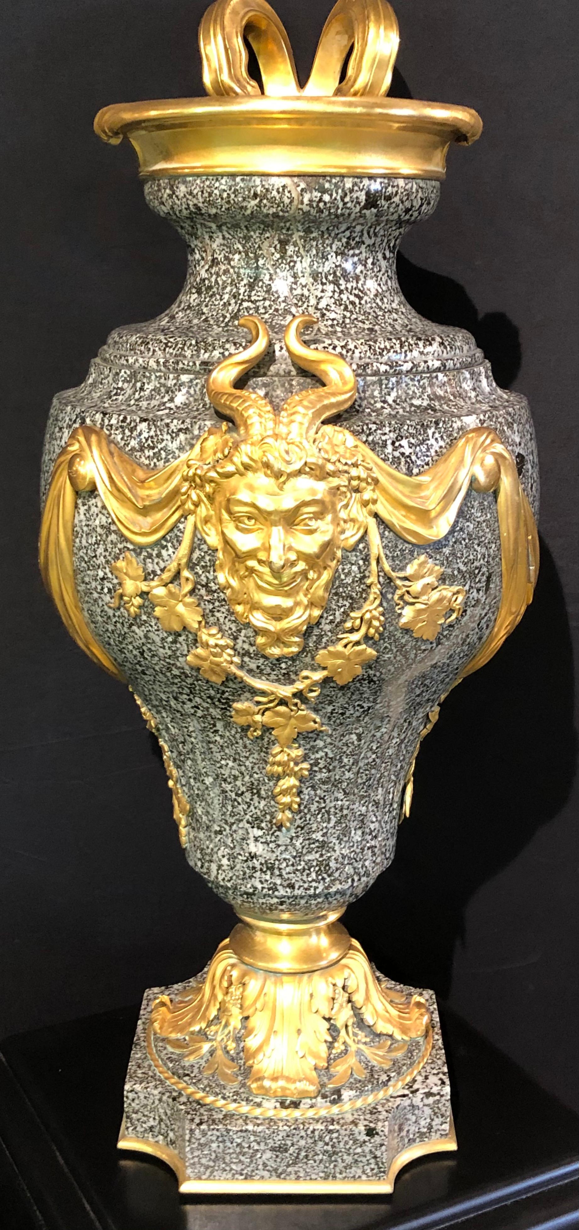 19th century Louis XV dore bronze mounted ewer / urn on a granite body. This large and impressive ewer or urn has its original brass inset encased in the solid granite gray black body. The whole having dore bronze adornments of drapery, swag and