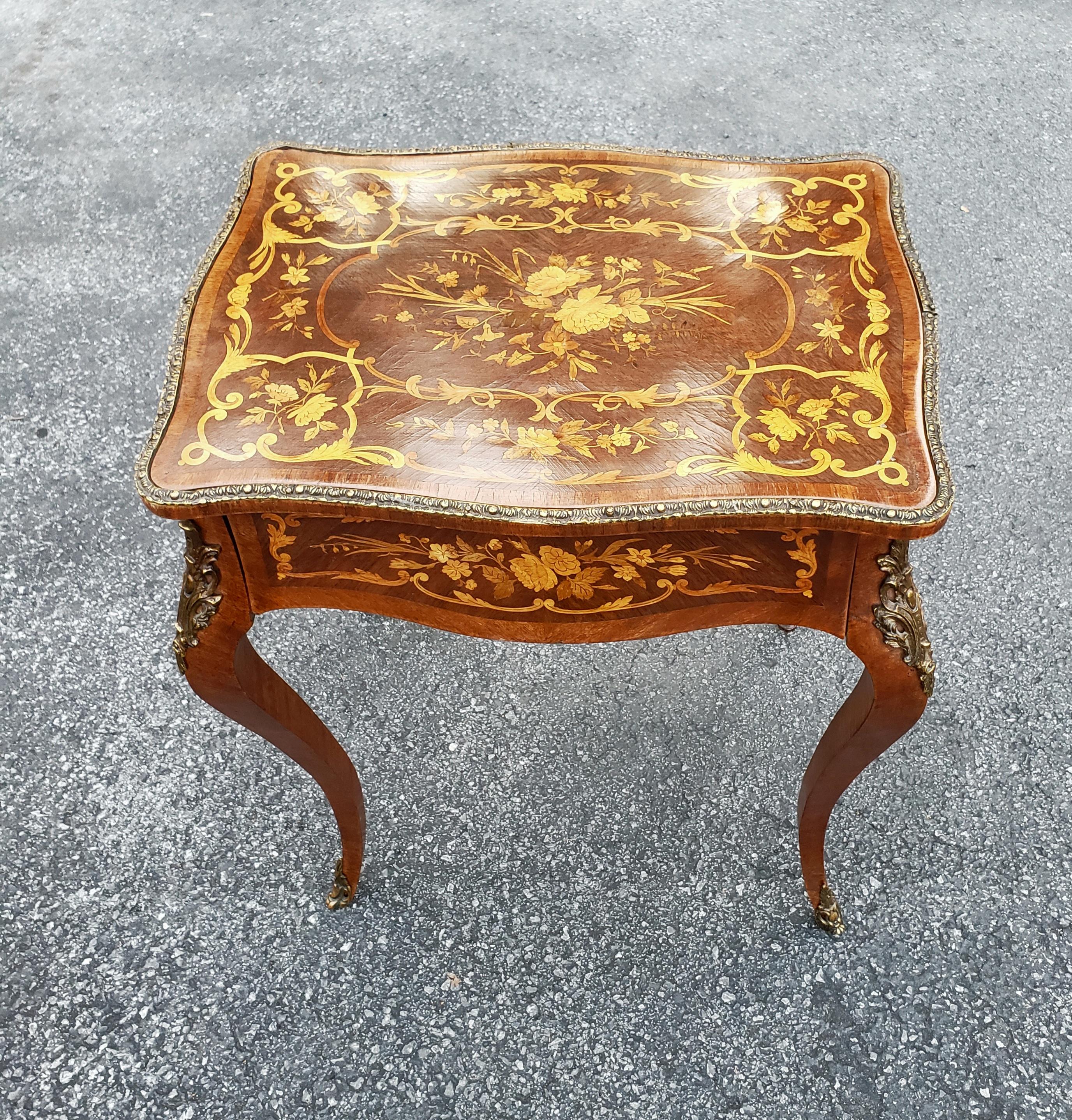 An exceptional Louis XV Style Dutch Marquetry Satinwood Inlaid and Mahogany Single-Drawer Side Table with ormalu mounted on cabriole legs. Measures 22.25