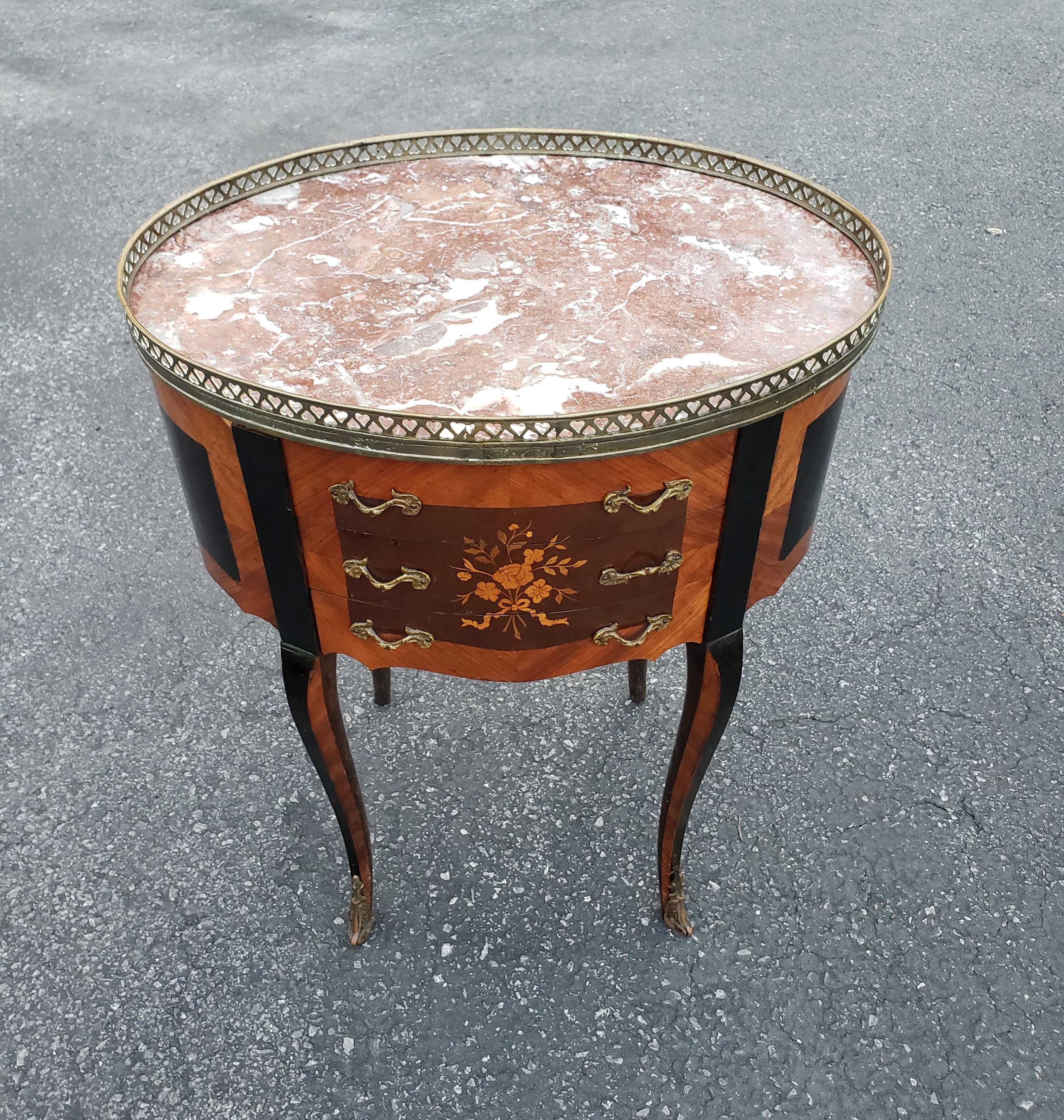 A  Louis XV style Ebonized Satinwood Inlaid Mahogany And Marble Inset Side Table with three nicely functional drawers. Measures 20