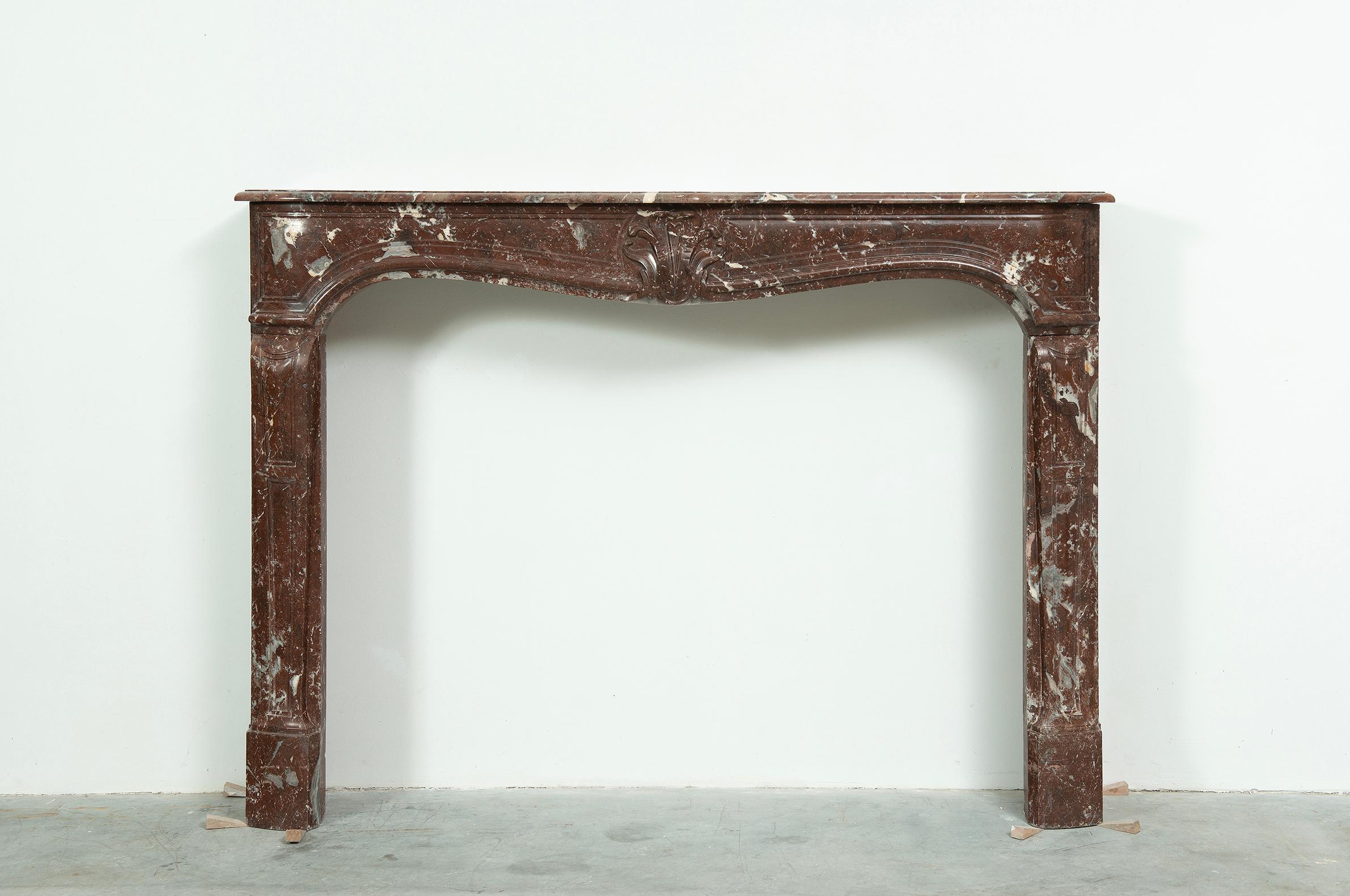 Louis XV Fireplace Mantel in Red Marble.

A very nice tall and elegant red marble fireplace in the style of Louis XV.

The lovely shaped and profiled  topshelf rest on a frieze that has a beautiful central decorations with panels on both sides.