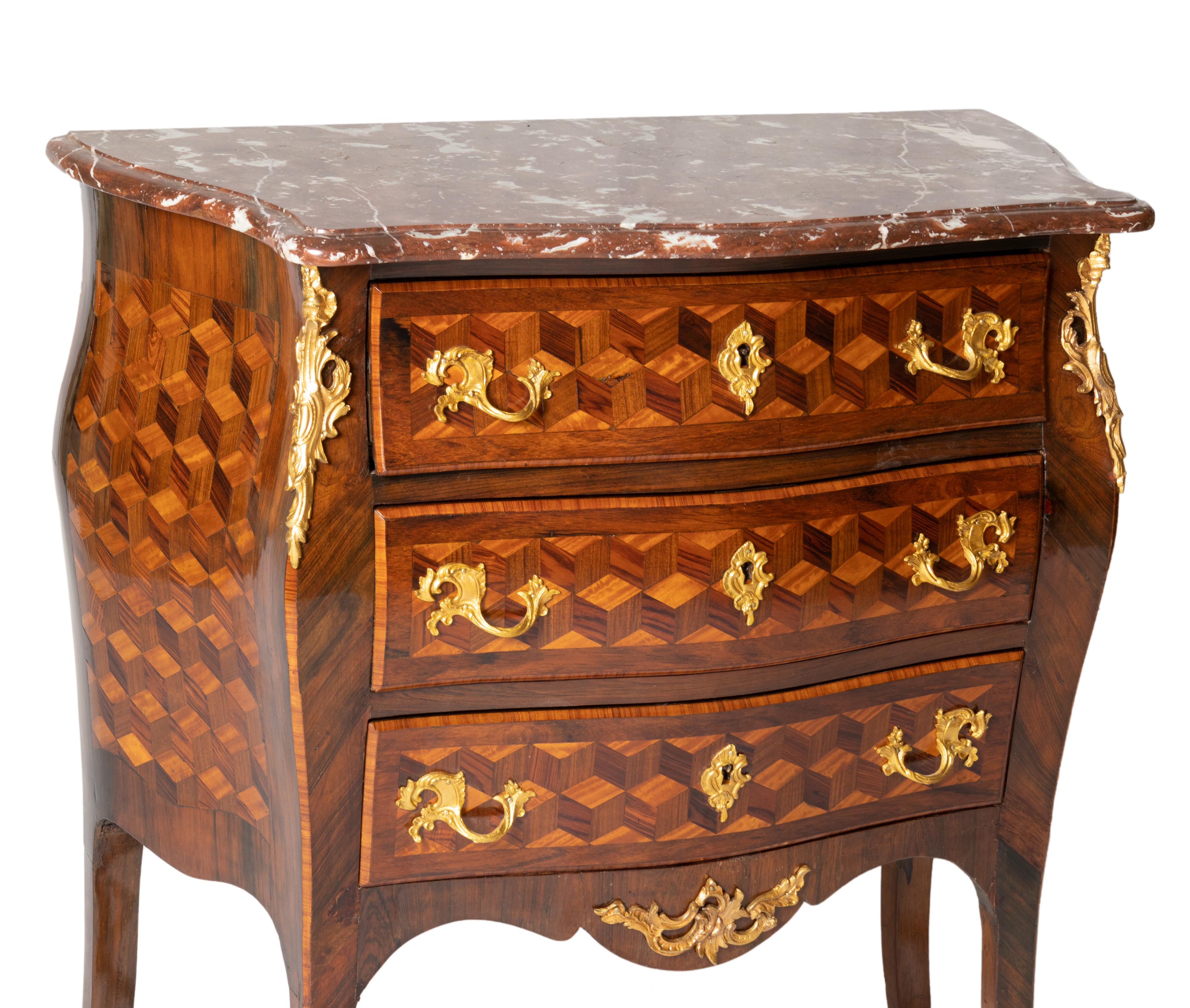 A french rosewood and burled walnut commode, stamped gilded bronze handles and three drawers. 
The upper drawer has three internal drawers, a François Hugnet piece, an accomplished artisan from the Faubourg Saint-Antoine Street, Paris.  

In 1846