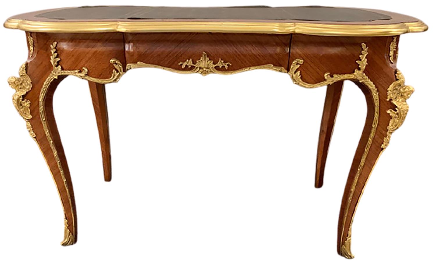 Louis XV Francois Linke style ladies desk having heavy solid bronze mounts. The corners depicting full busted woman leading to curved legs of bronze framing on bronze sabots. The whole supporting a tooled leather top. This desk can sit center room