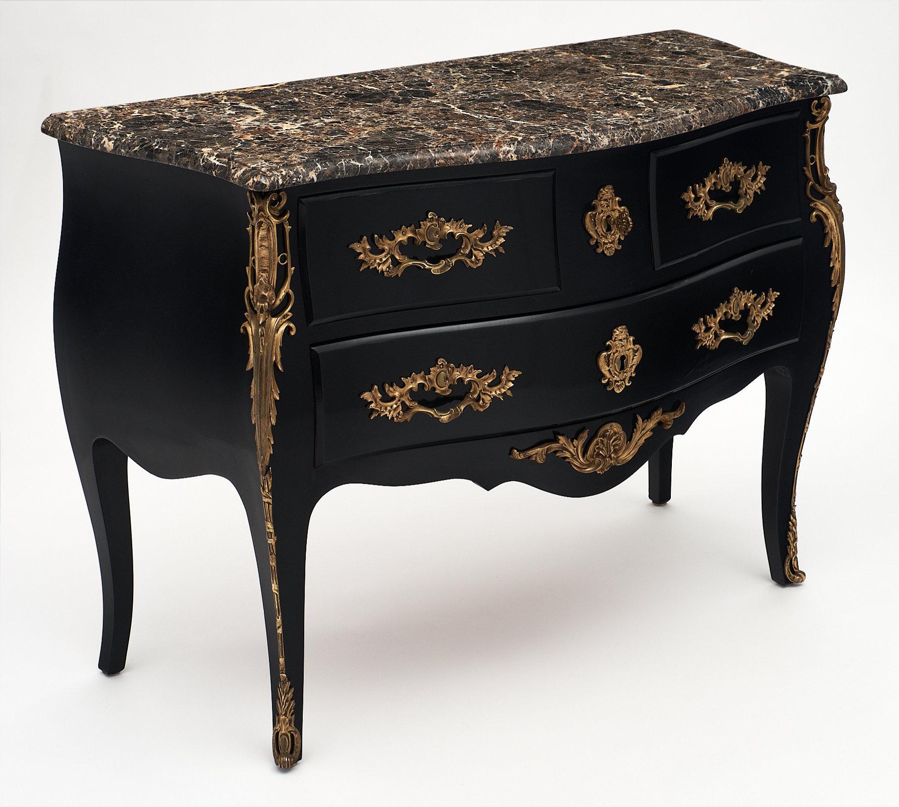 Superb French antique Louis XV “commode” chest of drawers featuring a Brêche royal marble top. This piece is made of ebonized rosewood finished with a lustrous French polish that contrasts beautifully with the bronze mounts. It is adorned with very