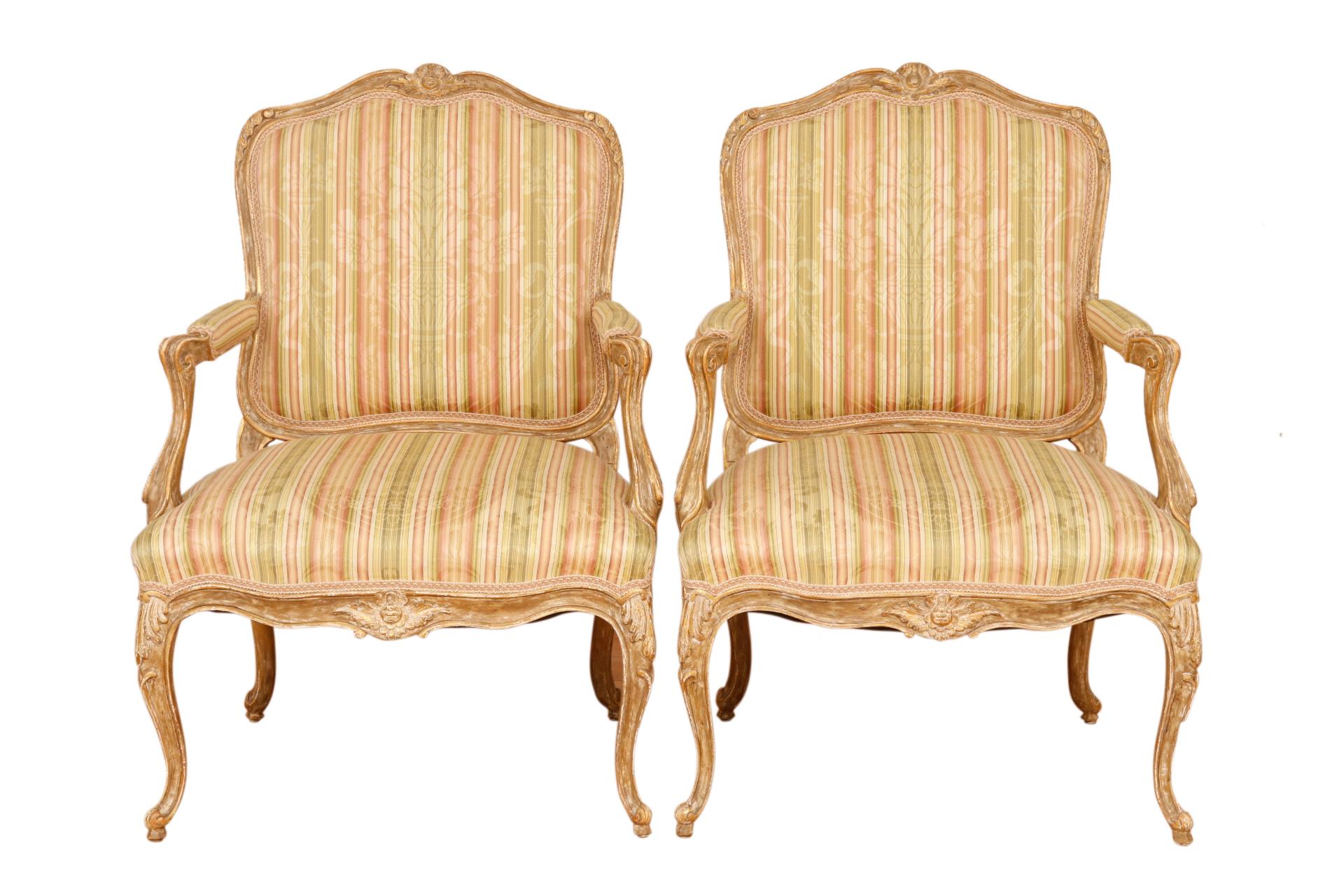 A pair of French Louis XV style fauteuils a la Reine. Seats are upholstered in a silken striped brocade secured with braided gimp. A classical floral vase and ribbon motif is superimposed over vertical stripes in sage, blush and cream. In the back