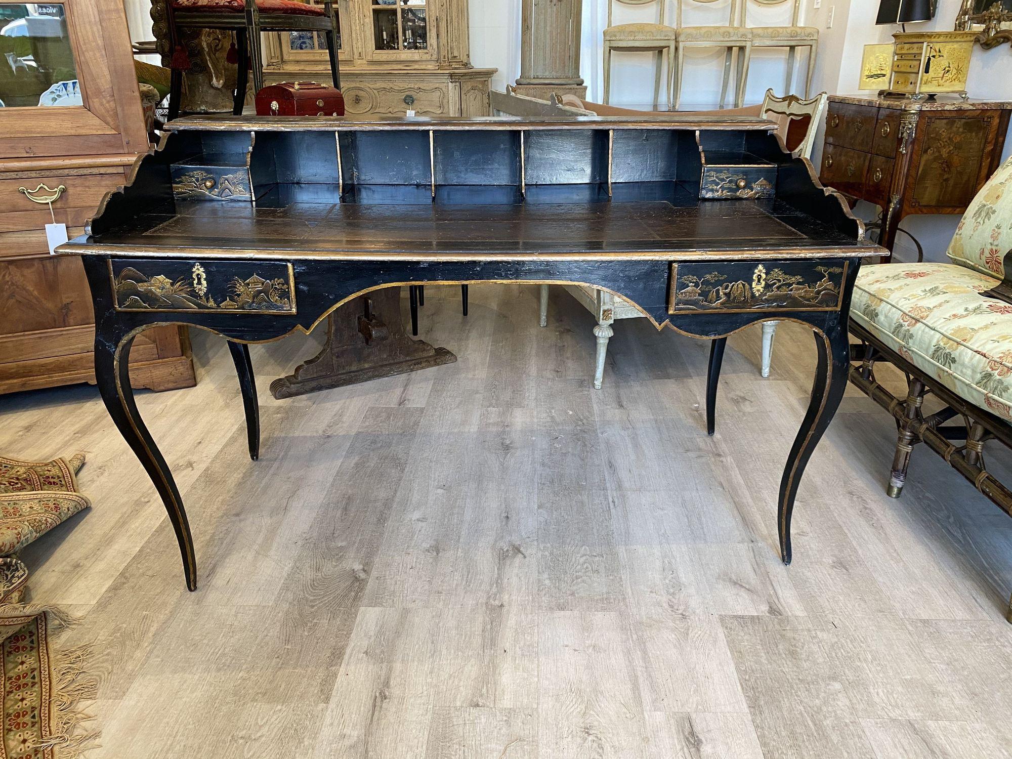 18th century French chinoiserie Bureau desk with original leather top. A gallery with 7 cubby holes and two short drawers over a flat top having original leather over a molded skirt and two long drawers. Restorations to leather and paint; all