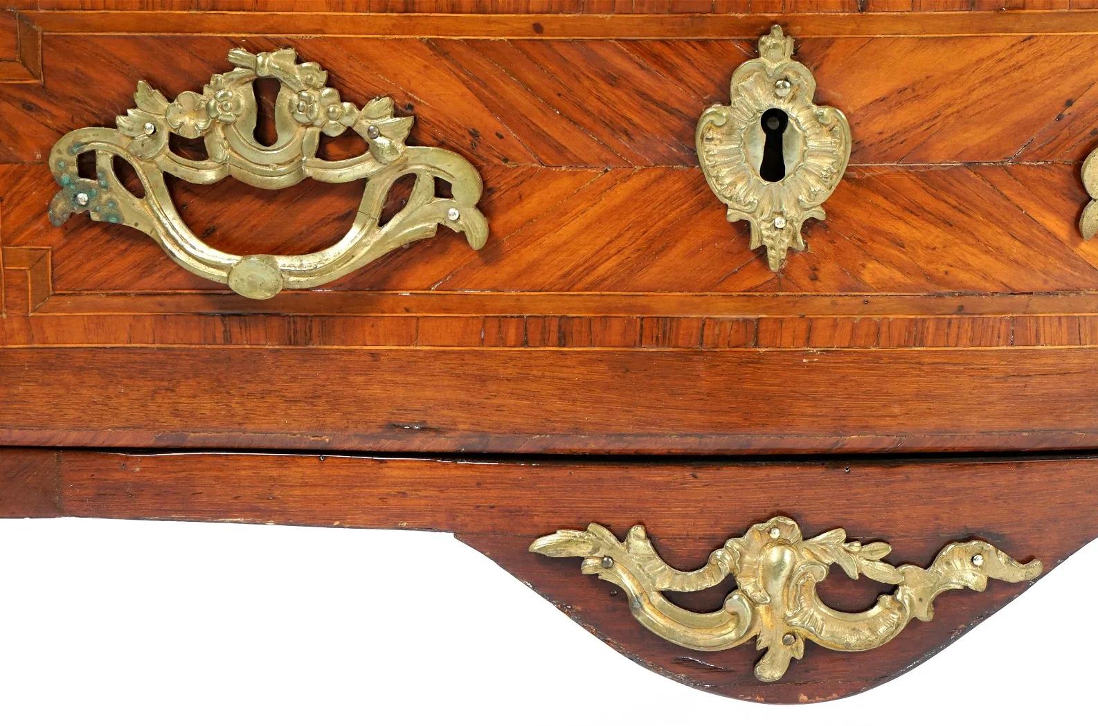 This is a masterpiece of 18th Century French Commode with exquisite inlay made from walnut, satinwood and tulipwood. In the bombe form having three drawers with original bronze handles. Ormolu bronze mounts on the corners and sabots on the feet. The