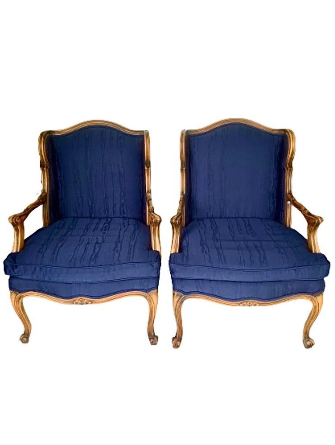 A pair of stunning Louis XV French Provincial style club chairs or lounge chairs.

Carved walnut, with deep blue faux bois patterned upholstery. 

Measures: 26.5