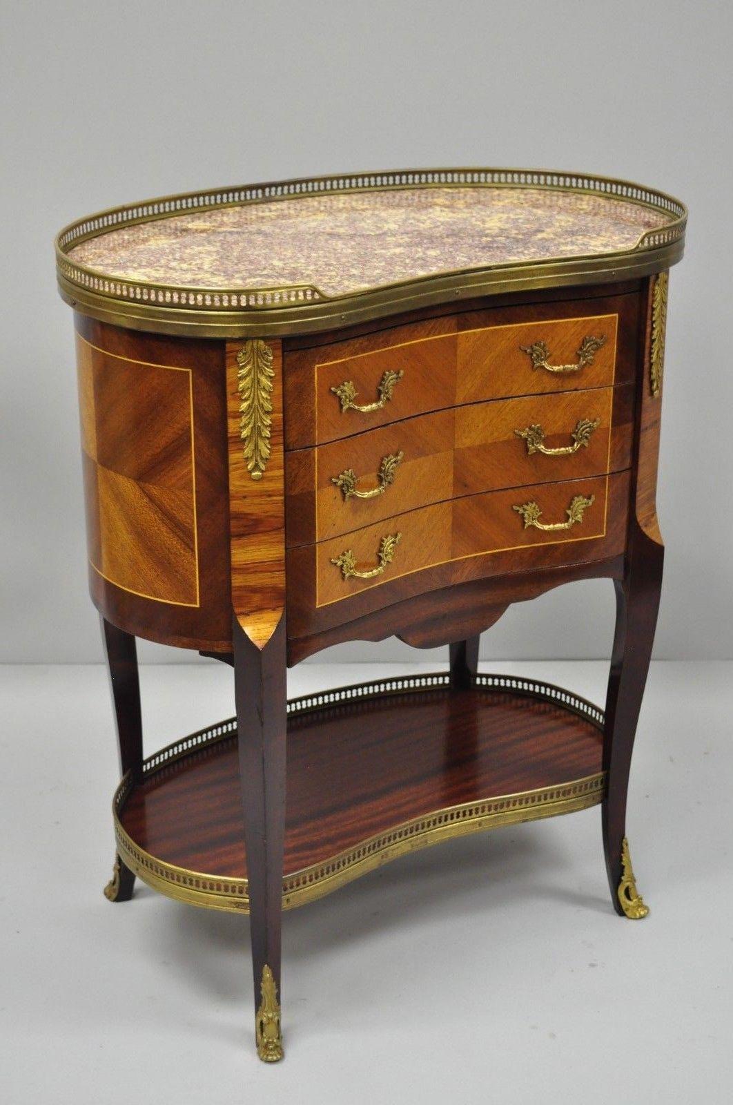 Louis XV French style kidney shaped marble-top nightstand end table. Item features inset pink marble top, kidney shaped, brass accents, 3 drawers, cabriole legs, nice inlay, great style and form, circa late 20th century. Measurements: 28.5