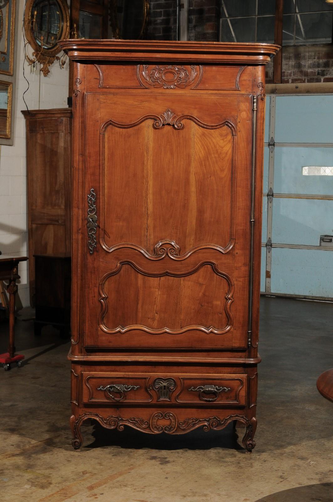 French Louis XV bonnetiere / single door armoire with carved paneled door and lower drawer on cabriole feet.