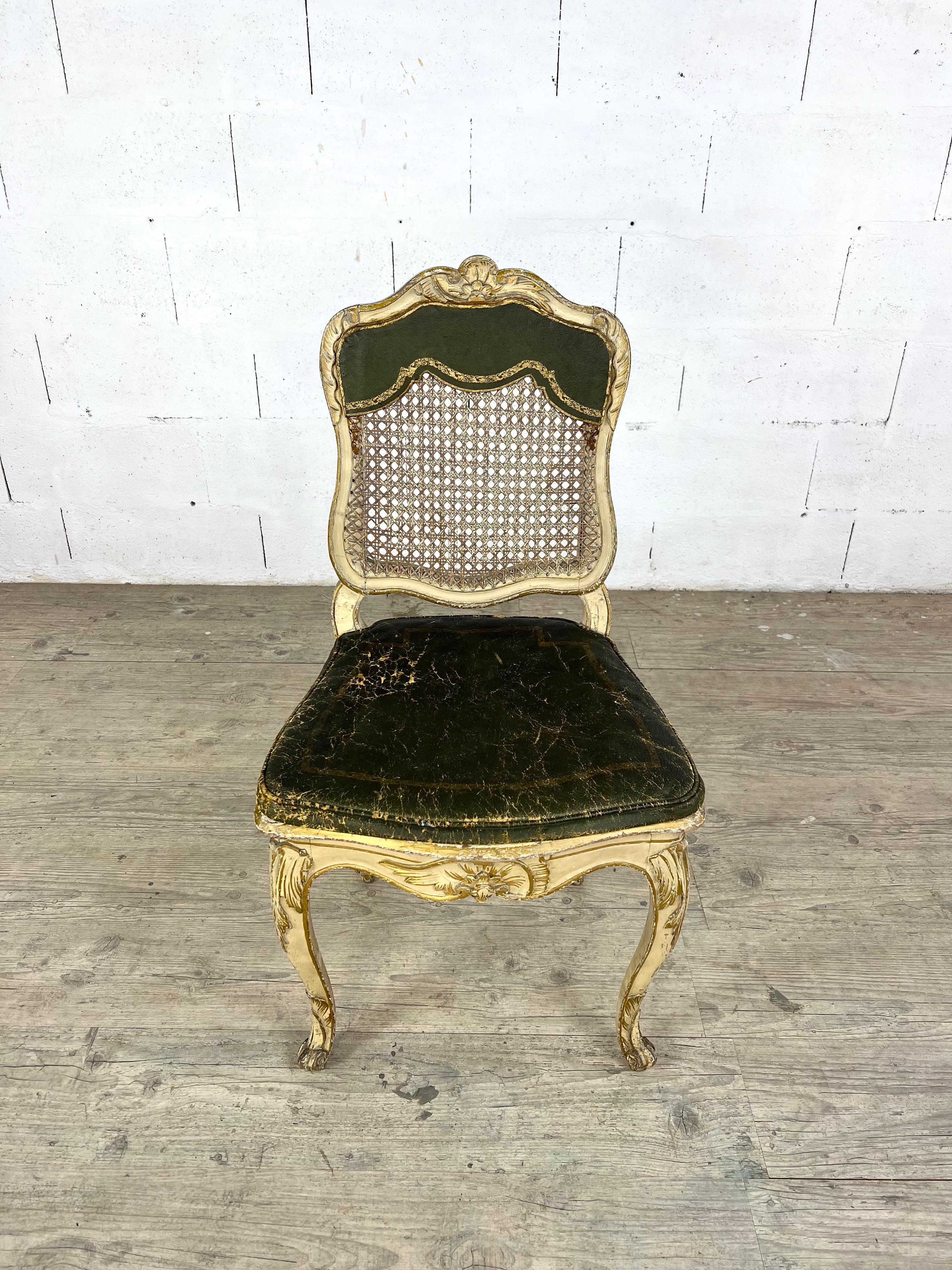 Refined Louis XV chair in carved and gilded wood, dating from the 18th century, featuring a original cane backrest and seat and a leather seat cushion with original green patina. This graceful piece embodies the Rococo spirit with its elegant