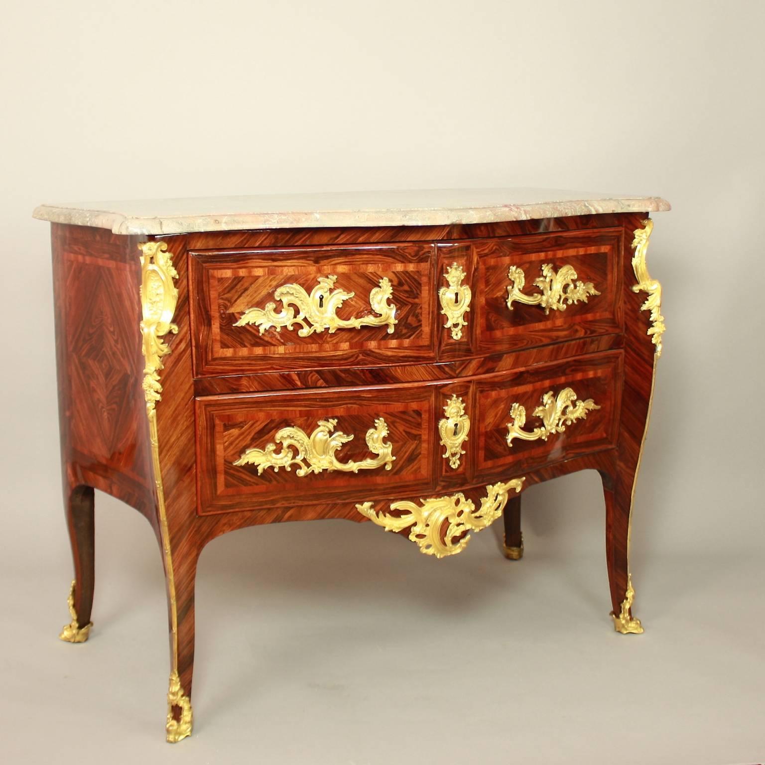 A Louis XV gilt bronze-mounted kingwood commode, stamped on the top of the left front stile carrying the name of M F Rubestuck (1722-1785). 
The commode displays a bombe front, with two small top drawers and one large bottom drawer, raised on four