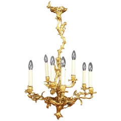 Lustre à neuf lumières en bronze doré de style Louis XV