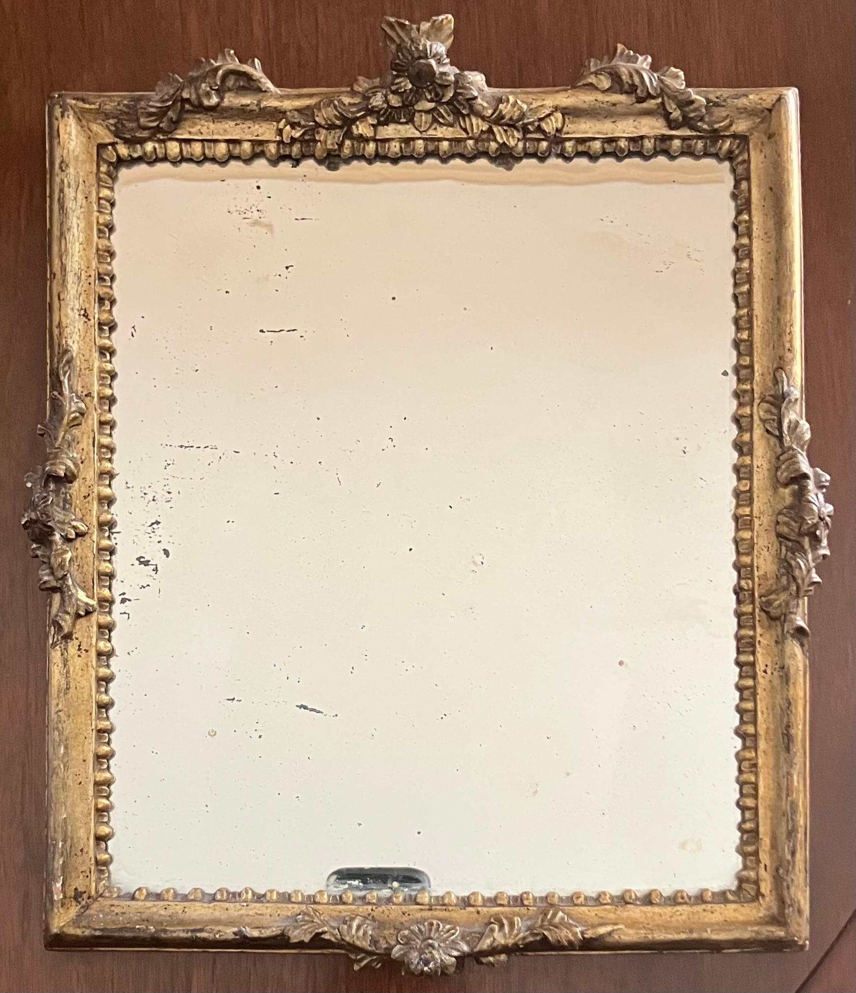 Miroir au mercure Louis XV, sculpté et doré. Miroir de petite taille au cadre doré délicatement sculpté, avec une moulure intérieure en forme d'œuf et un nœud floral sculpté centré sur chaque côté, avec un fabuleux miroir en verre plat au mercure