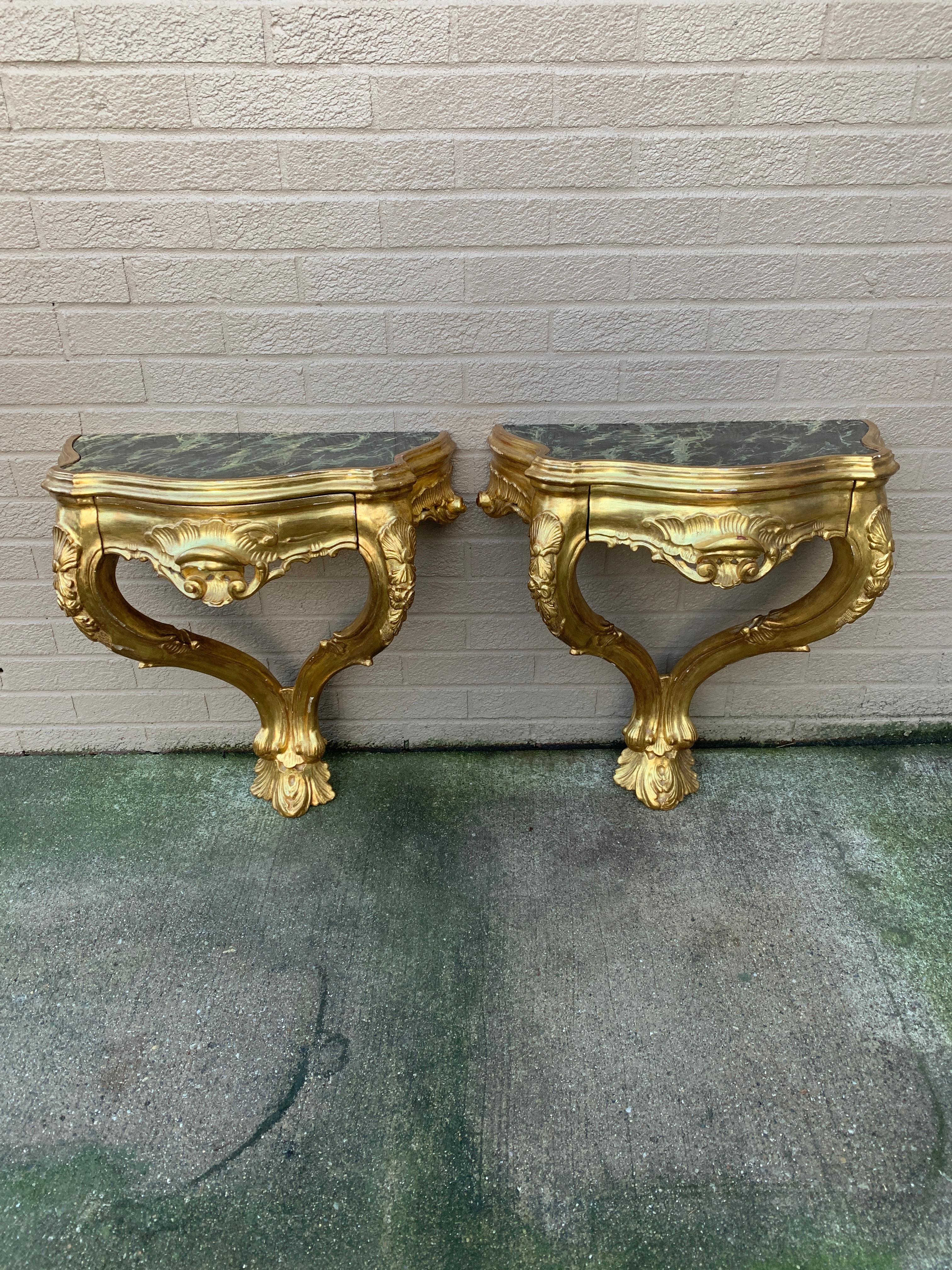 A gorgeous pair of French Provincial Louis XV style one-drawer wall-mounted console bedside tables or nightstands

Italy, Circa Mid-20th Century

Carved gilt wood, with hand-painted faux marble tops

Measures: 22