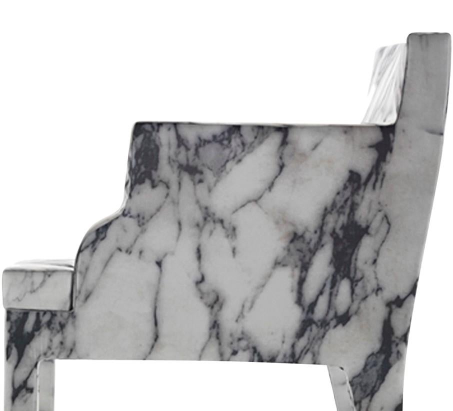 More than a mere revisitation of Classic forms, this chair with armrests transforms a French-inspired design into an original seating where the austere marble becomes unexpectedly soft and comfortable. Designed by Maurizio Galante and Tal Lancman,
