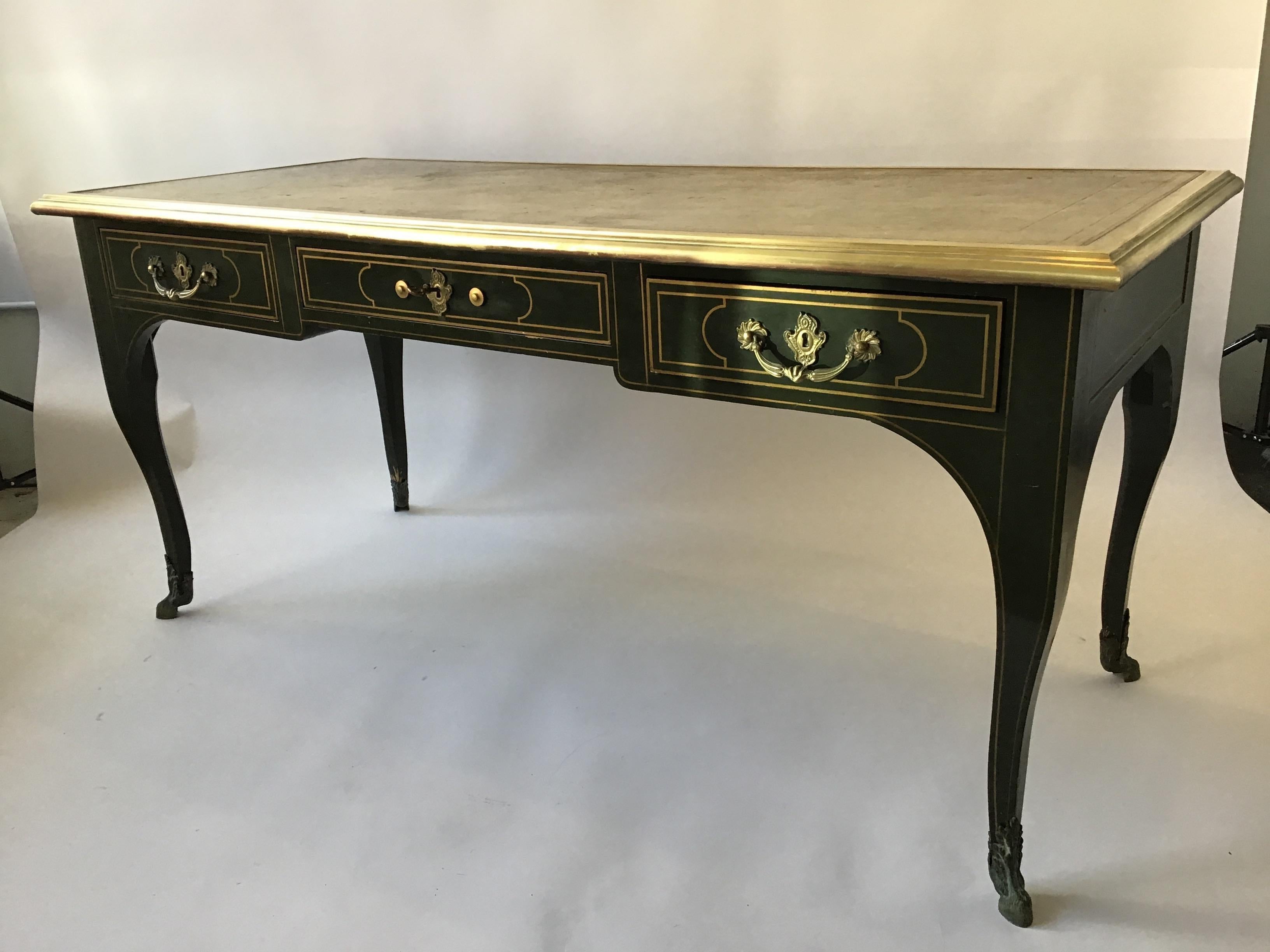 Bureau plat vert Louis XV par Baker. Dessus en cuir, garniture en laiton.