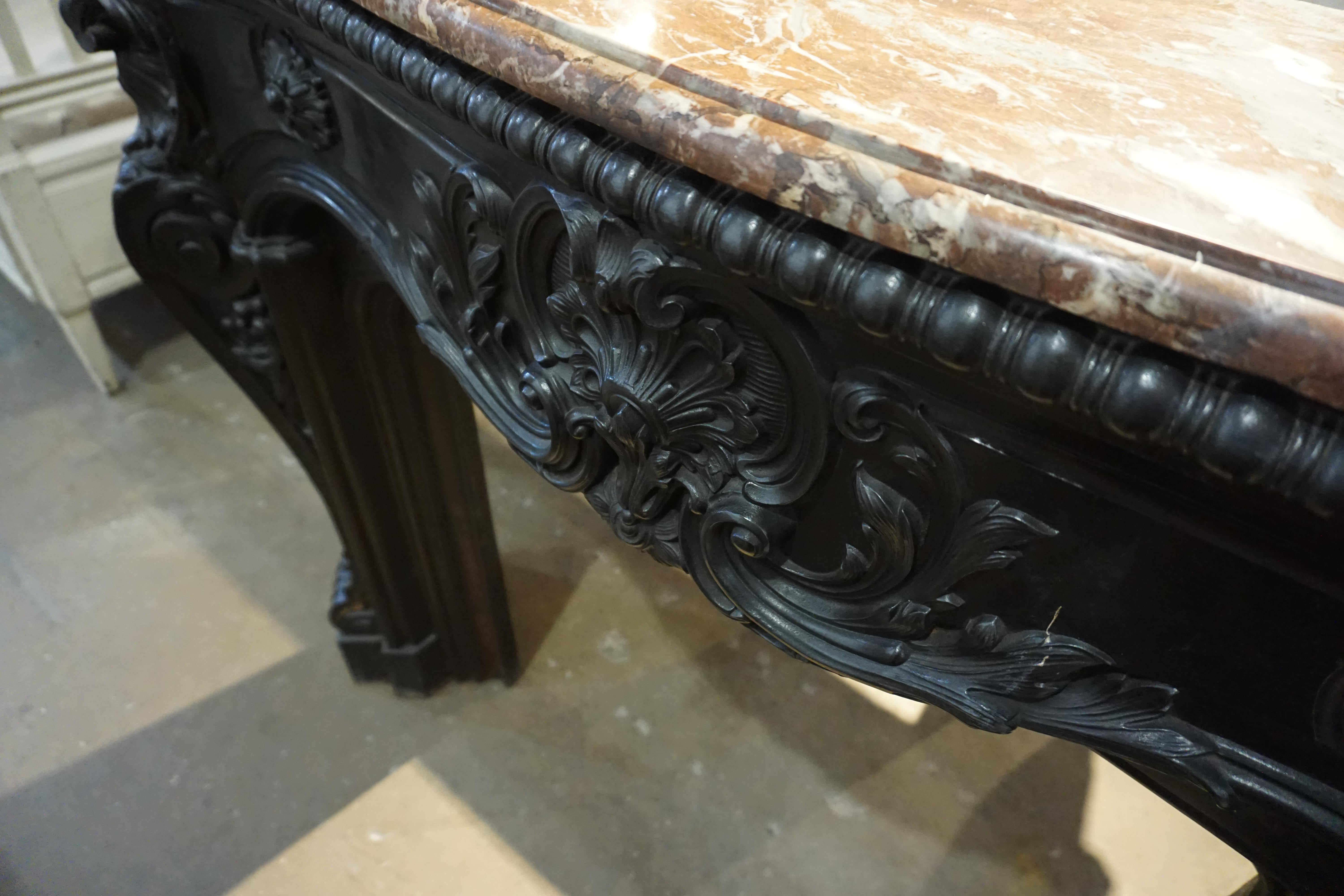 A unique mantel piece made of iron and marble. Originates from France circa the 1700s.

Measurements: 46'' W x 10.5'' D x 40'' H.