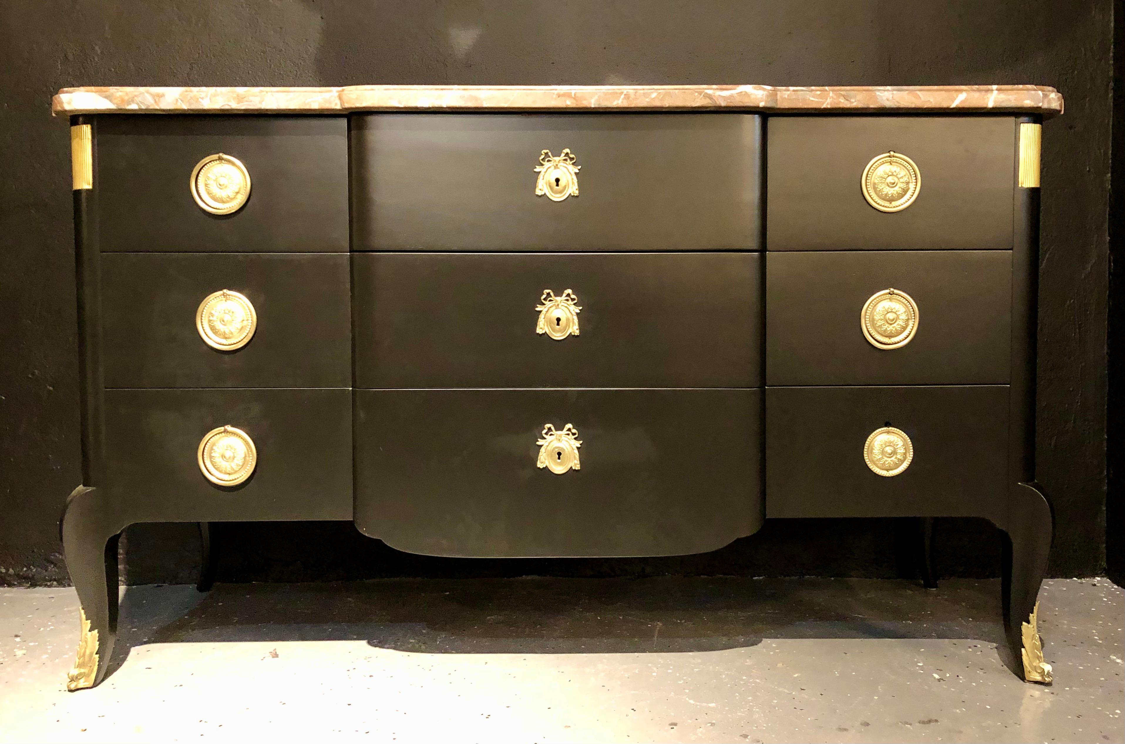 Louis XV style Jansen Dresser, commode or chest. This large and impressive ebony Hollywood Regency era commode is simply stunning. Having been recently refinished with nine drawers, three in the center flanked by three on each side with bronze