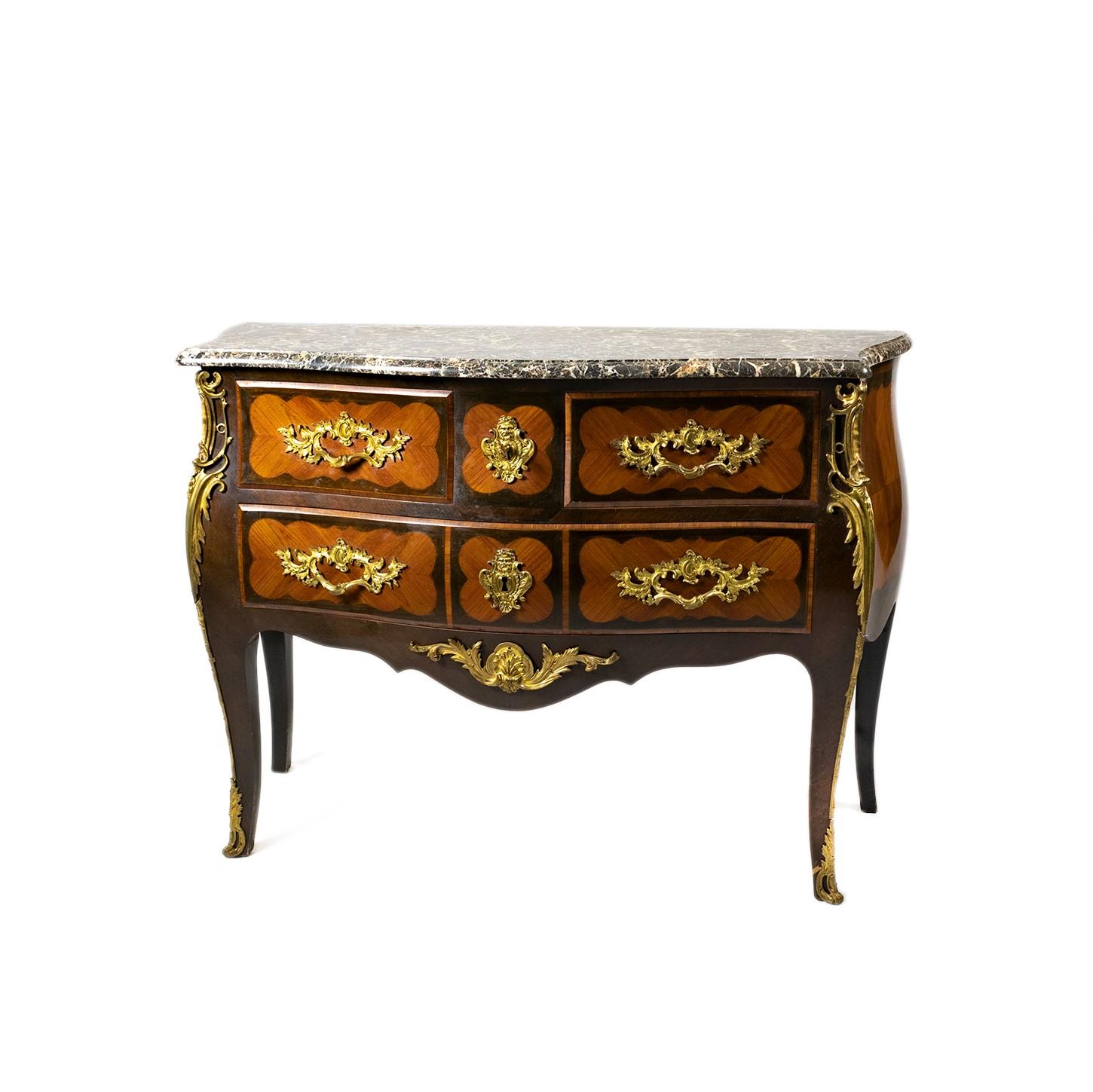 A kingwood commode with a bombé front, two drawers spanning the full width of the piece, and two smaller drawers above, tapering legs with scrolled caps, characteristic of Louis XV, gold-plated bronze fitting, elegantly-formed backplate handle and