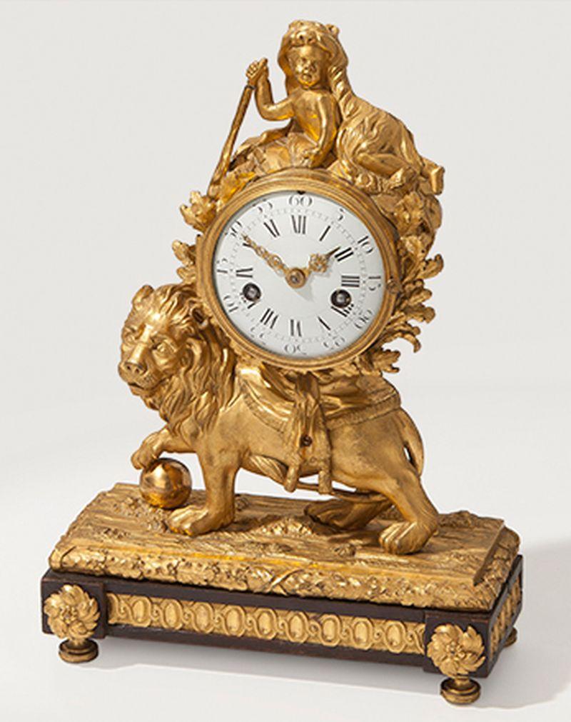 Eye-catching gilded bronze lion mantel clock, Louis XV, circa 1770.
3.5 inch enamel dial; bell striking movement with flat-bottomed plates and outside countwheel.
The drum case surmounted by a putto draped with a lion's pelt and raised on the back
