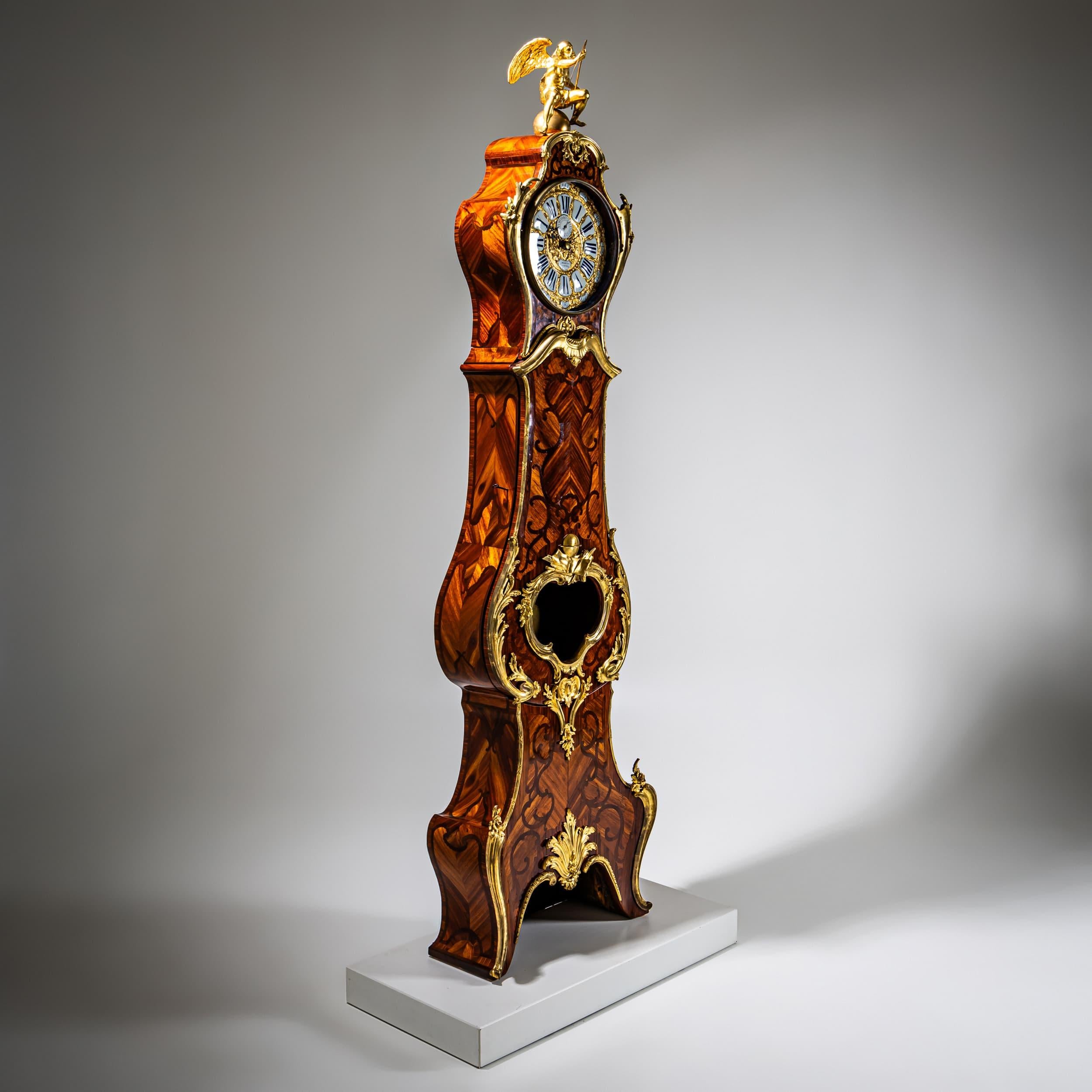 Grand French longcase clock in Louis XV style featuring a mahogany case adorned with finely cast and fire-gilt bronze mounts. The clock is surmounted by a fully sculpted figure of Chronos, the personification of time. The enamel and bronze dial