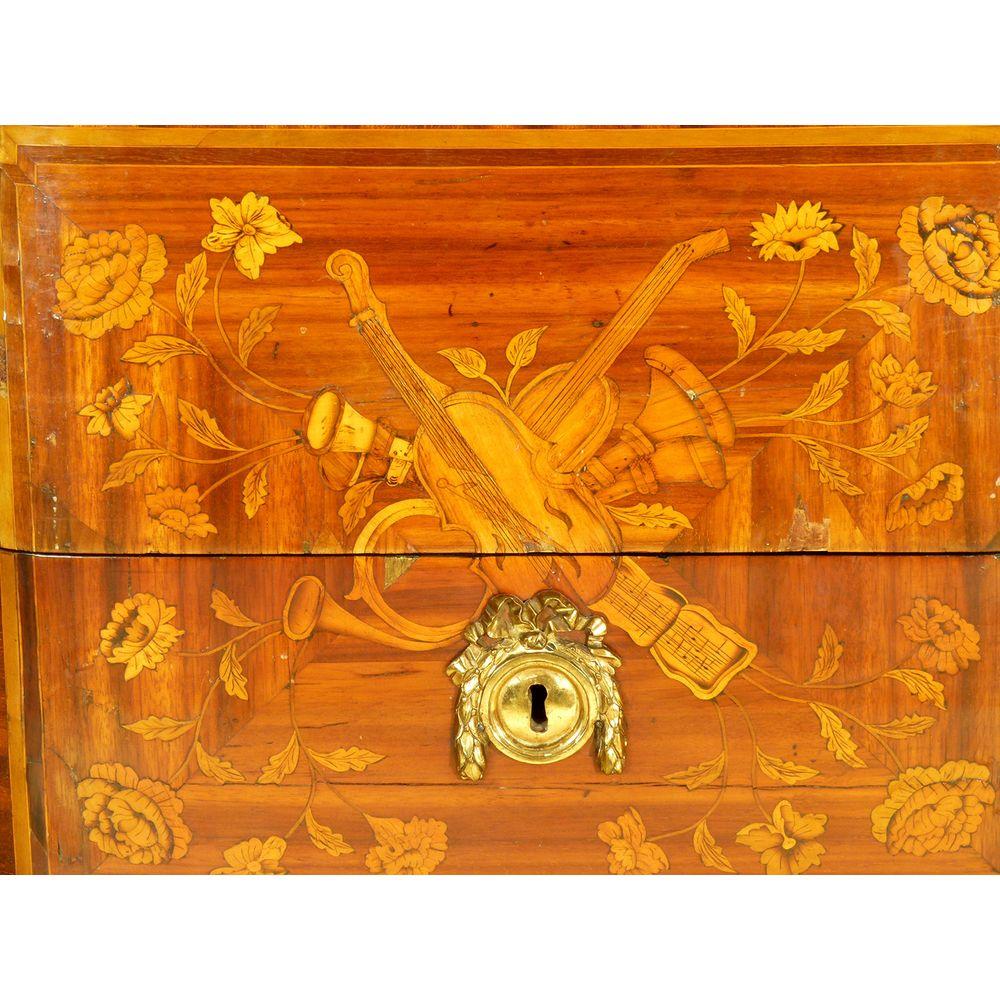 Louis XV ormolu-mounted transitional period commode or chest with amaranth, tulipwood & fruitwood marquetry and parquetry. Ca 1765. 

In superb condition. 

The two working drawer fronts centred by a marquetry panel of musical trophies. 

The canted