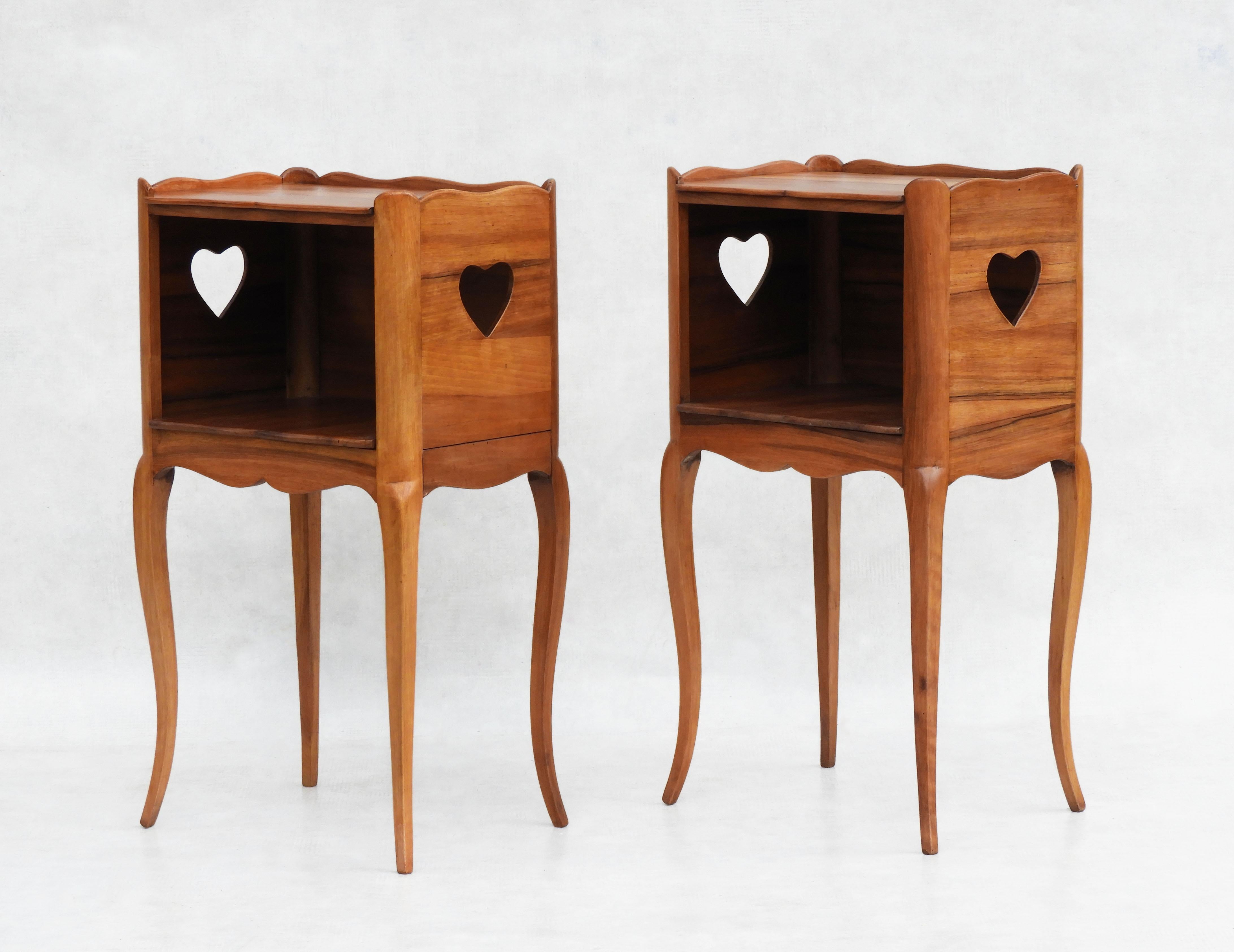Pair of French Louis XV Revival Nightstands/Bedside Tables C1950s

Gorgeous pair of French Louis XV style nightstands/bedside tables with a sweetheart motif.
A delightfully dainty duo with serpentine tray tops, open niche and hidden side drawer