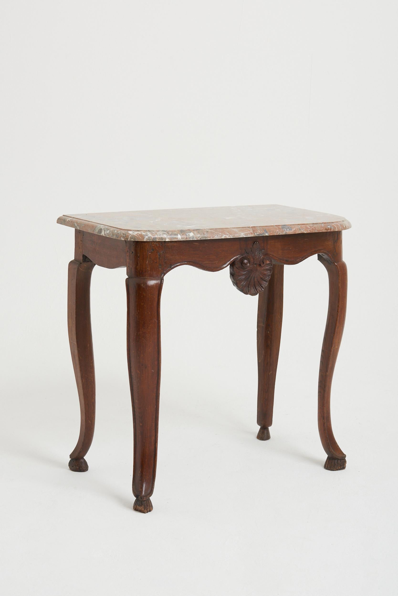 A provincial Louis XV period carved oak and marble top console table.
France, circa 1750.