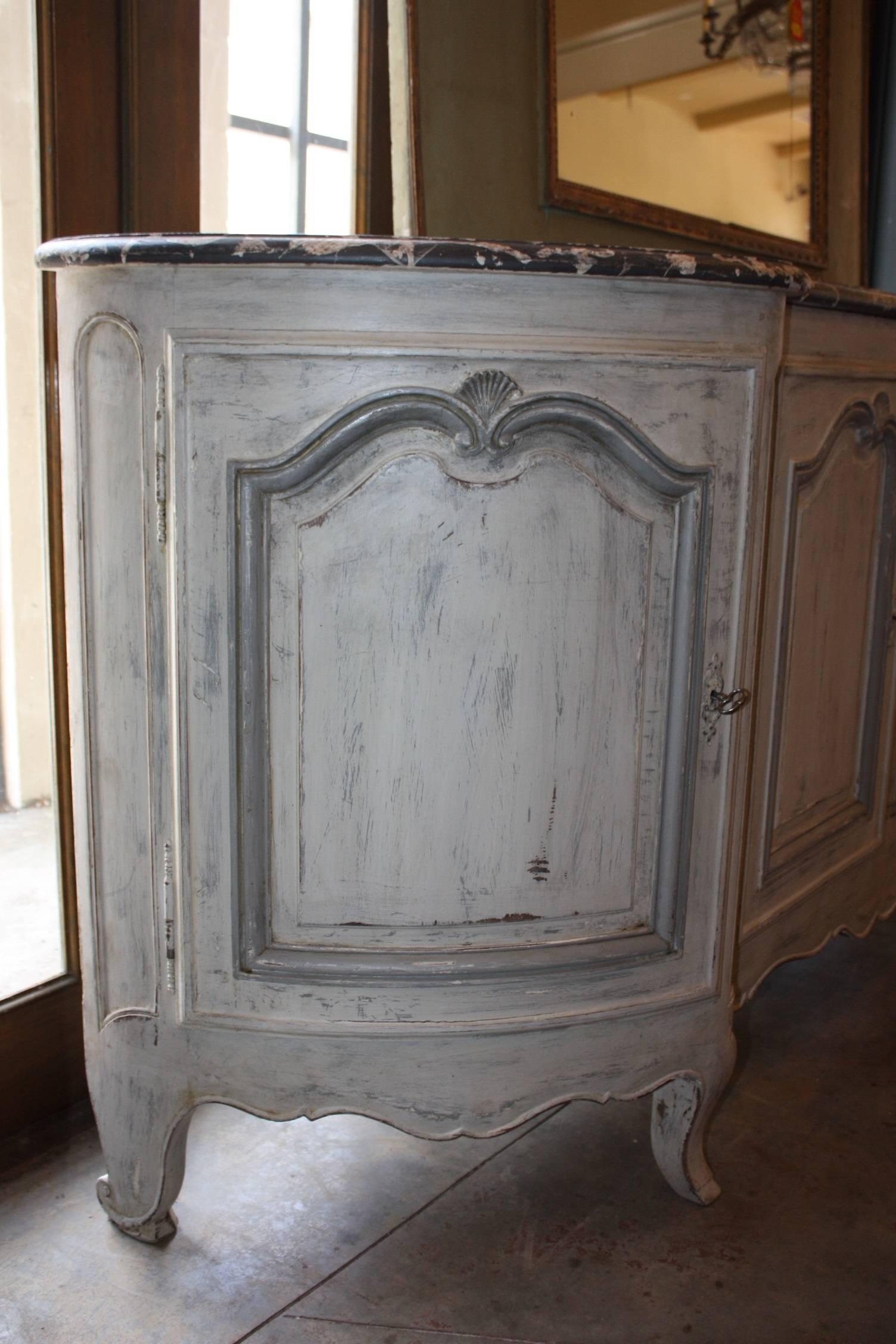 Painted French enfilade with faux marble top. Enfilade has four doors and two interior hidden drawers with original hardware. Hand carvings on the doors, drawers and on the bottom of the enfilade. It is painted a pale blue and white undertones while