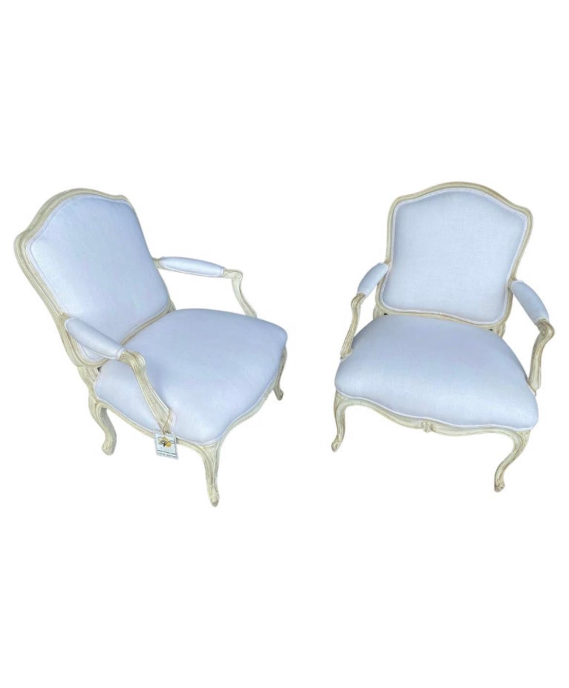 A beautiful pair of Louis XV style of chairs reupholstered in a white linen fabric. Perfect for any sitting room, at the foot of a bed, hallway and more. The fabric has been professionally cleaned since we had these imported from Italy but there are