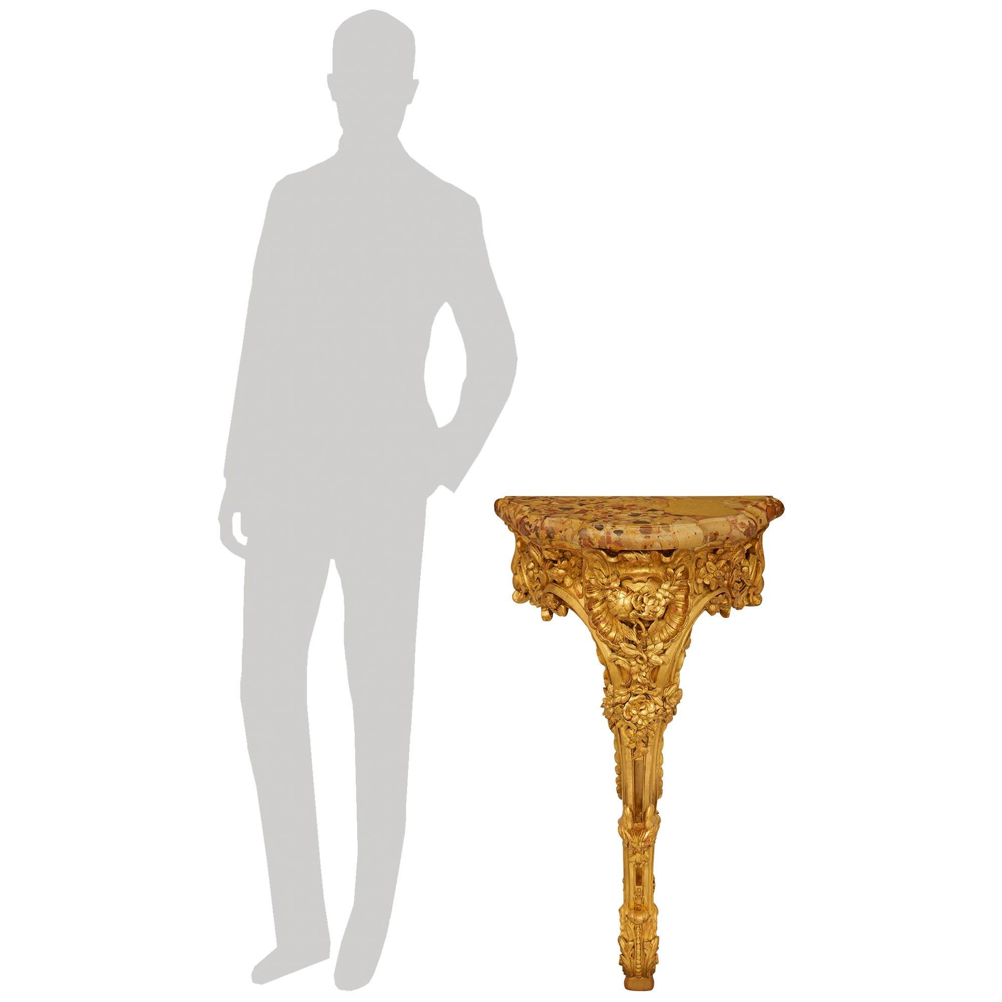 A sensational and richly carved French 18th century Louis XV Period Giltwood and Breche D'Alep marble console. This wonderful and most unique console is raised by an intricately carved scrolled leg decorated with wonderfully detailed acanthus leaves