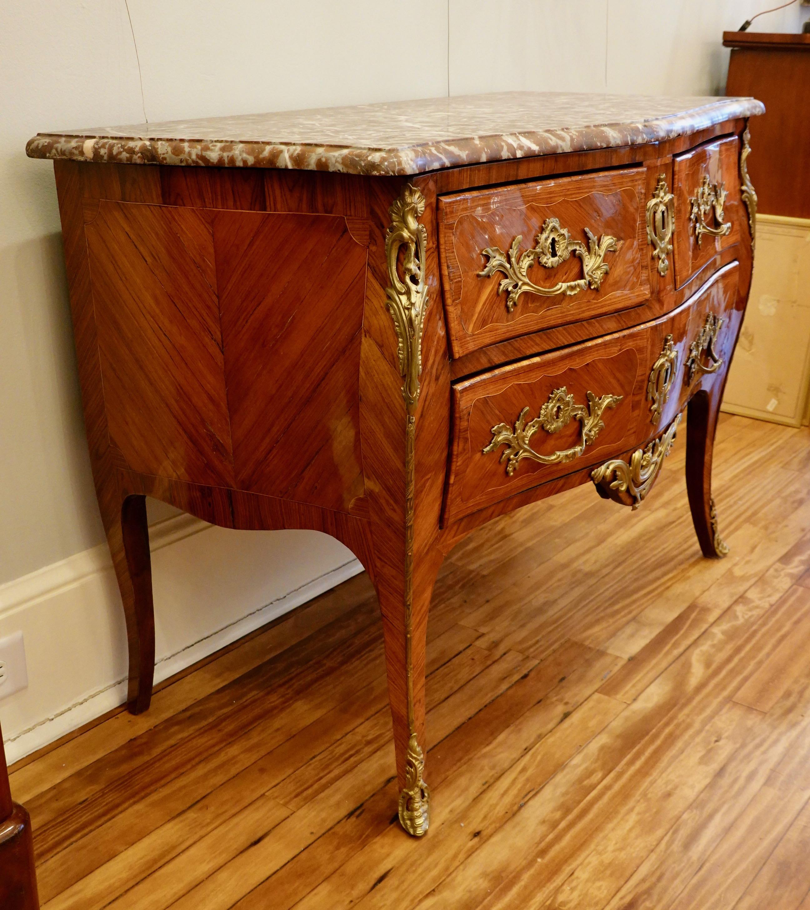 French Louis XV Period Marquetry Stamped Commode with Rouge Royale Marble Top For Sale