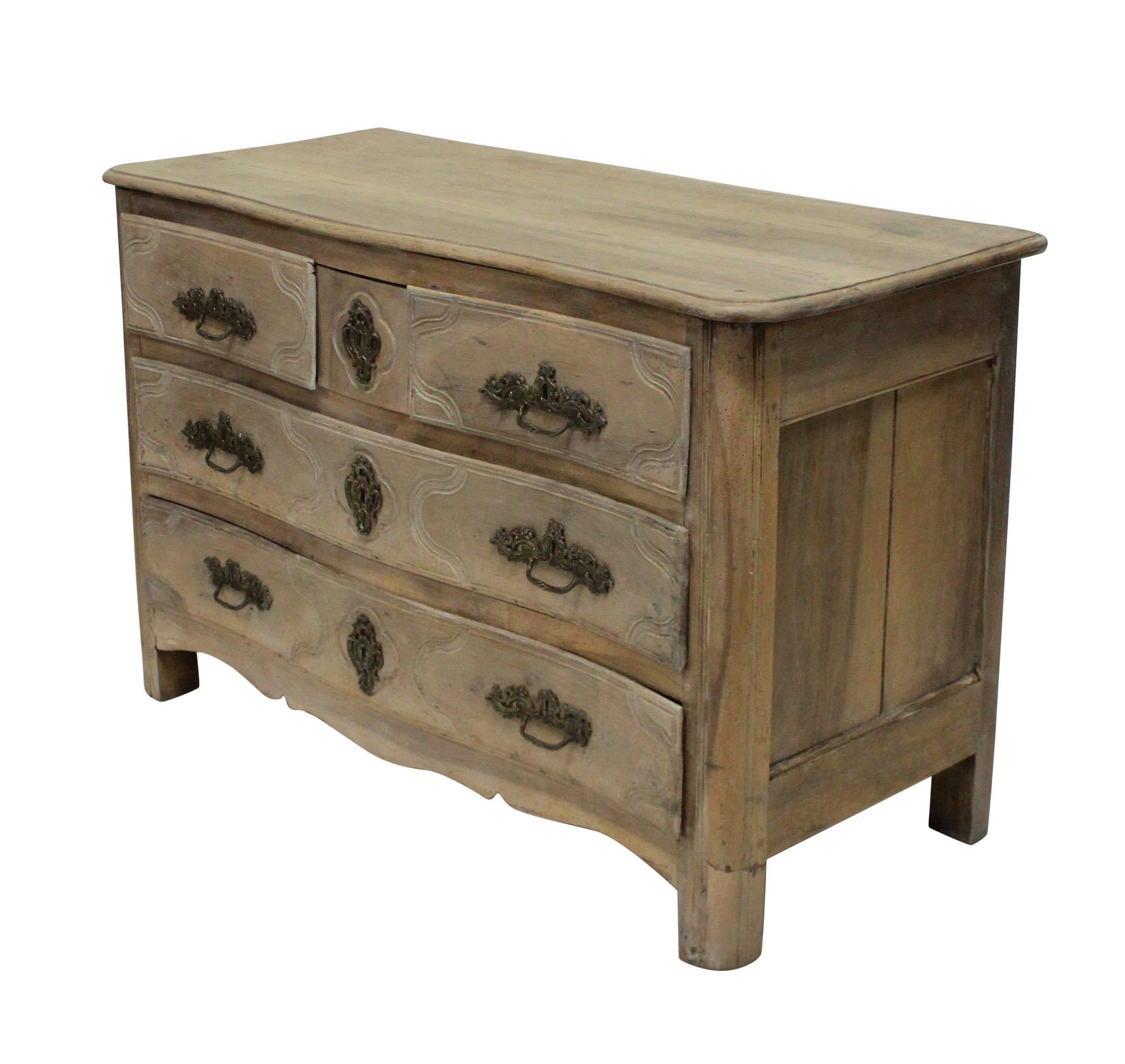 A pickled 18th century French Louis XV walnut commode, with serpentine front and five drawers. The original handles in bronze. Pickling was a popular trend in the 1920s-1930s.