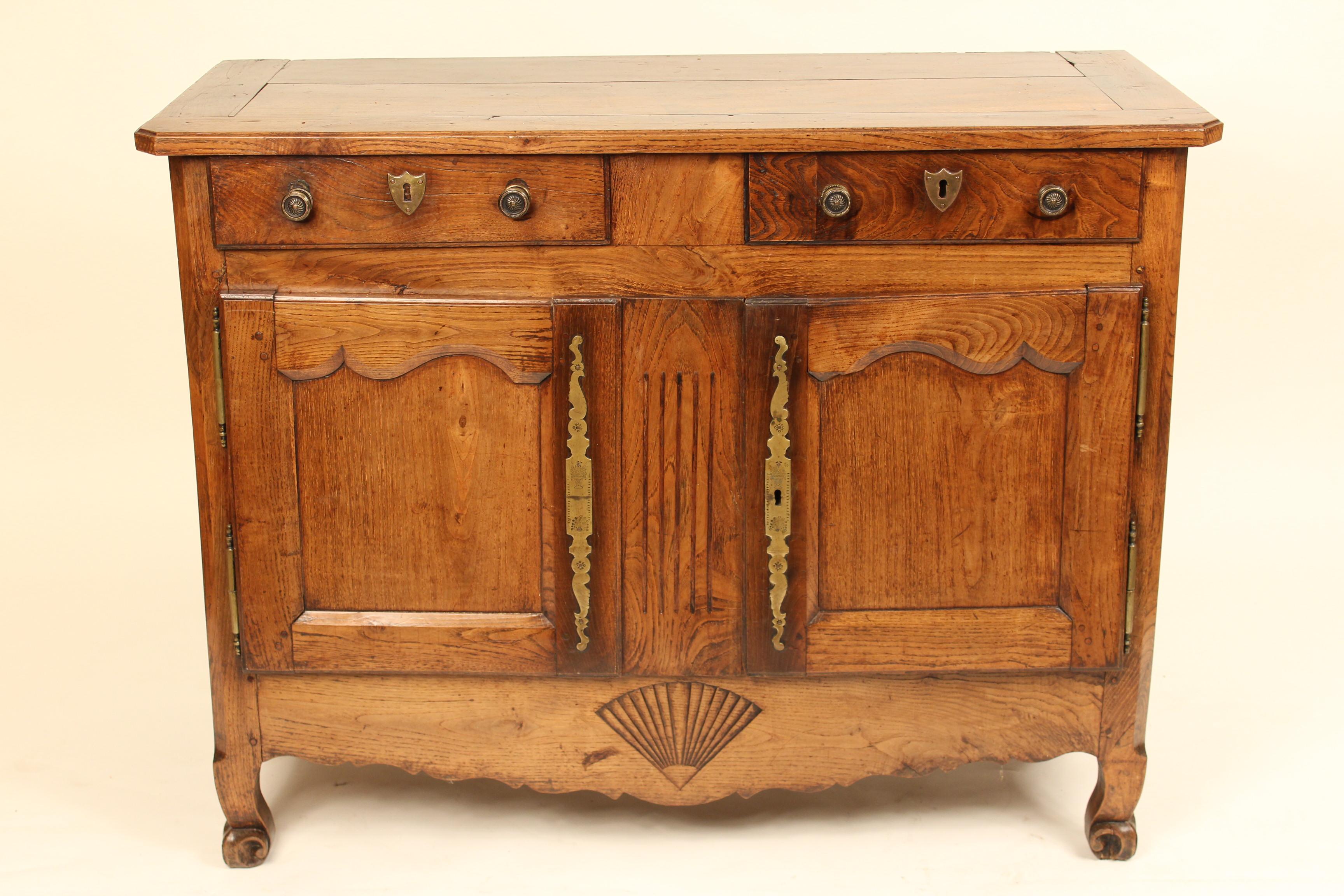 Louis XV provincial oak and walnut buffet, early 19th century. Very usable buffet with excellent color, mortise and tenon construction, decorative brass escutcheons, and French fiddle feet. Drawer bottoms and sides rebuilt.