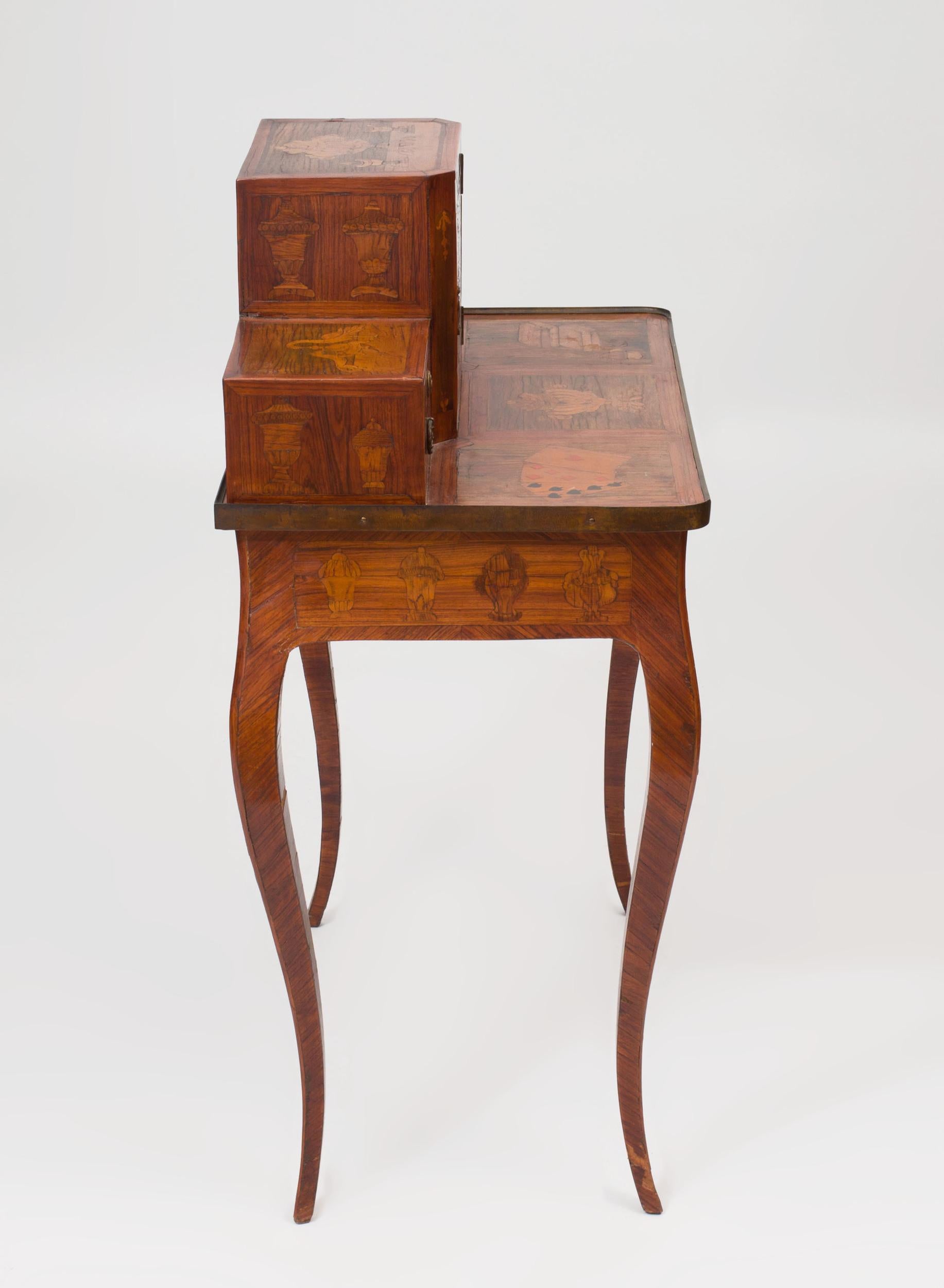 Louis XV Provincial Bon du Jour (ladies writing desk) with fruitwood and kingwood pictorial marquetry inlay depicting a hand of cards, urns, books and dogs and a goose.