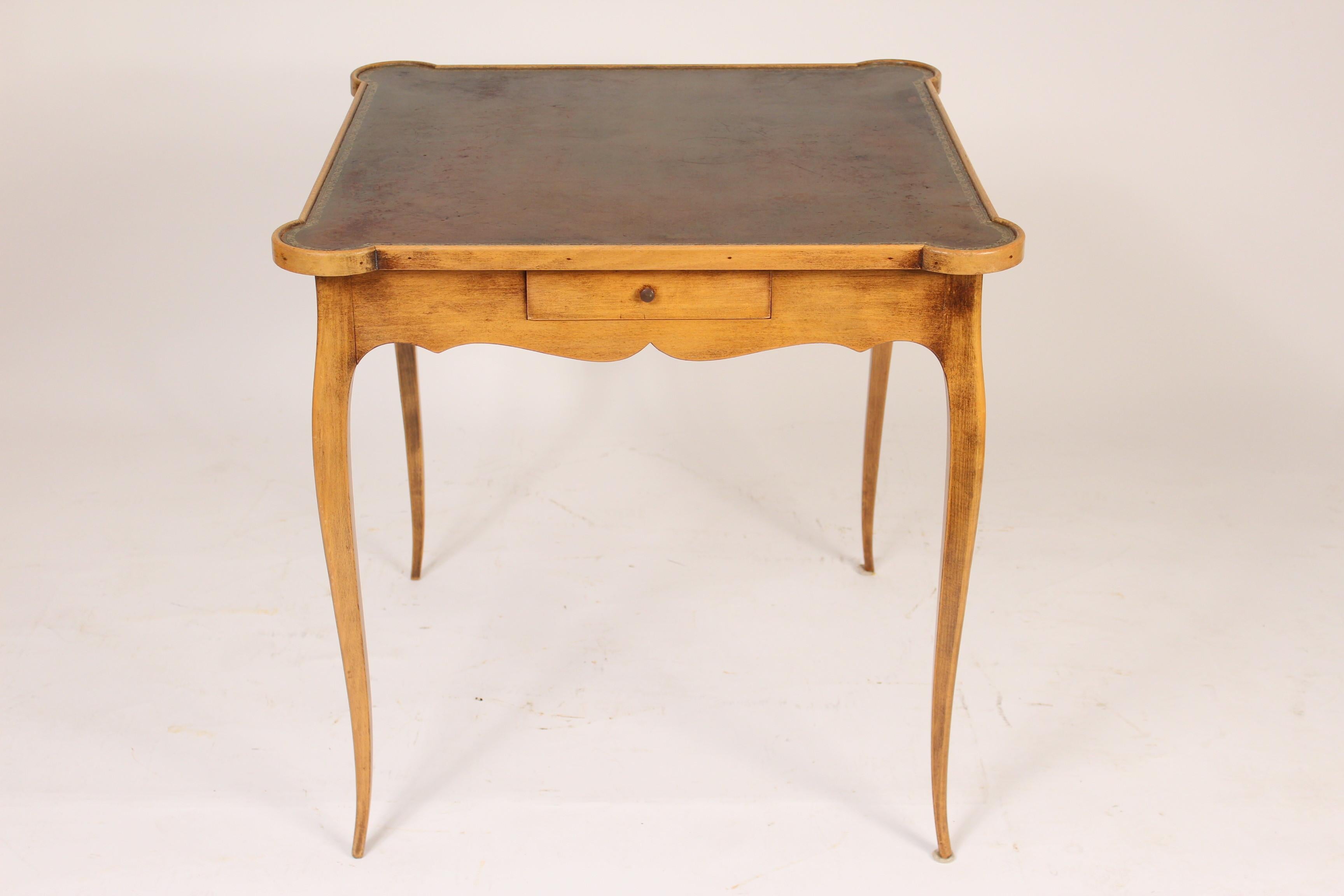 Louis XV Provincial style fruitwood games table with a tooled leather top, mid-20th century.