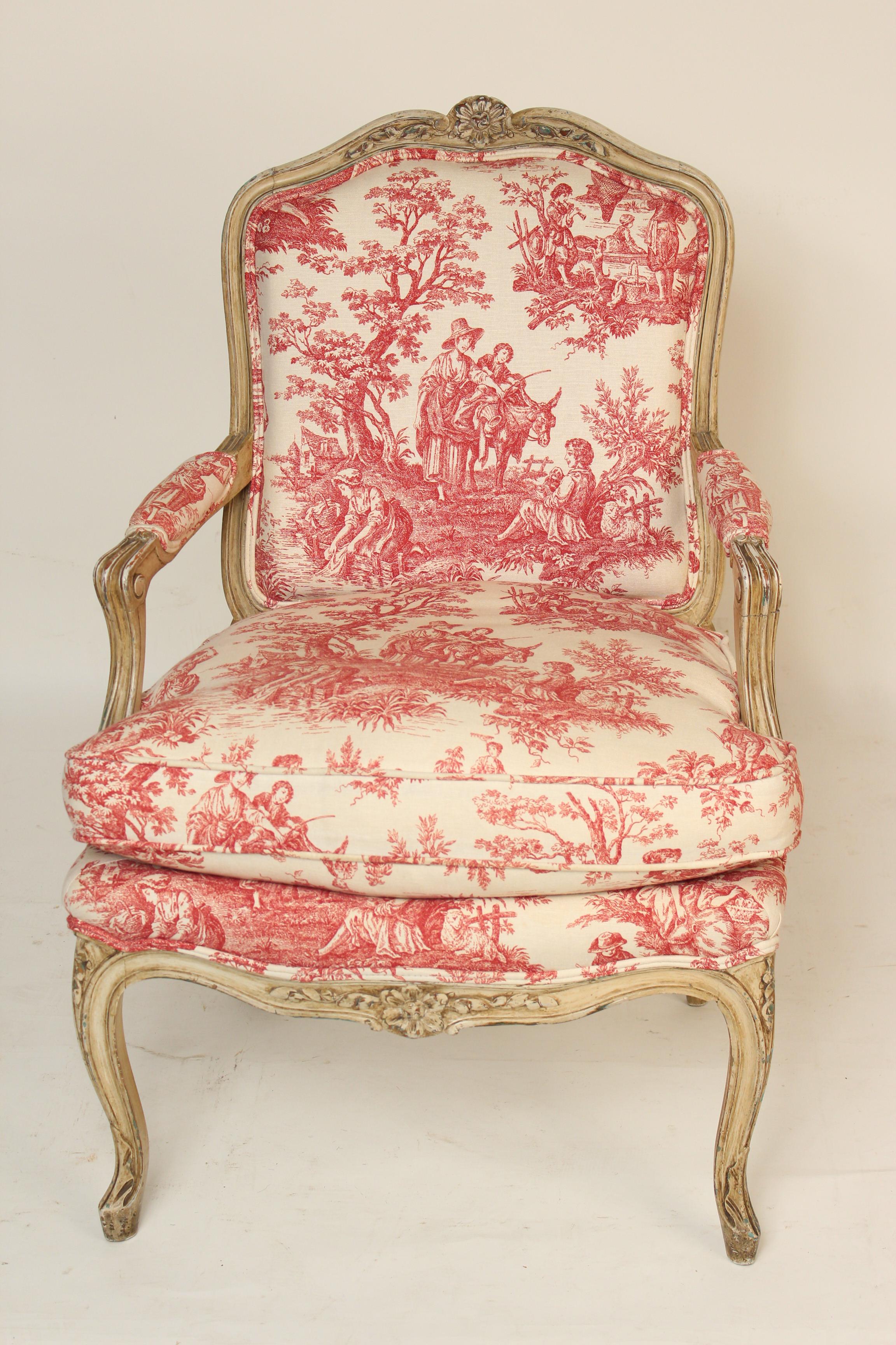 Louis XV Provincial style painted armchair with red toile upholstery, circa 1930. The seat cushion is 50% goose feathers and 50% down.