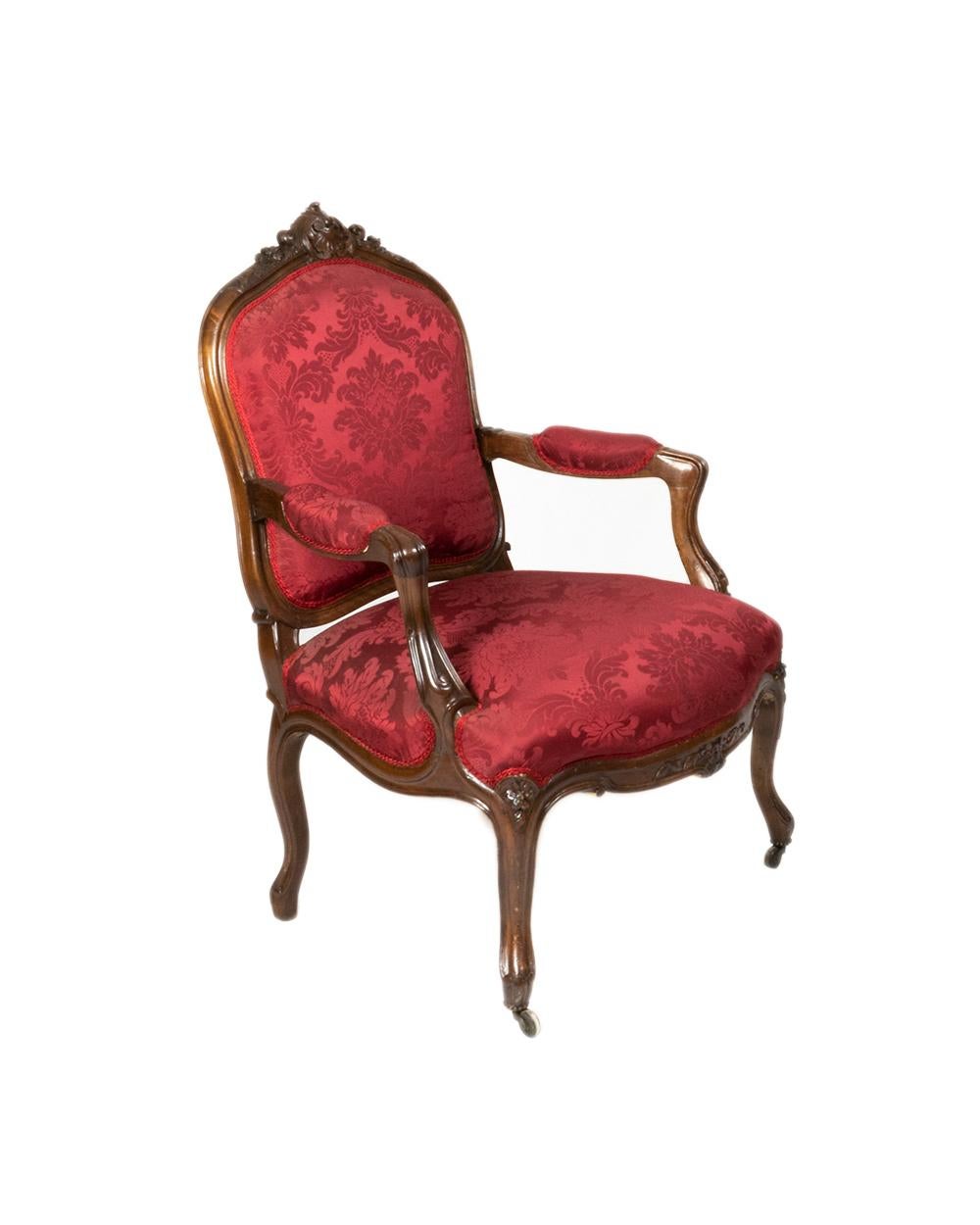 A armchair, fauteuil à la Reine with back in the style of Jean Baptiste Cresson with headlines of the armrests and seat upholstered and covered with red silk damask, 