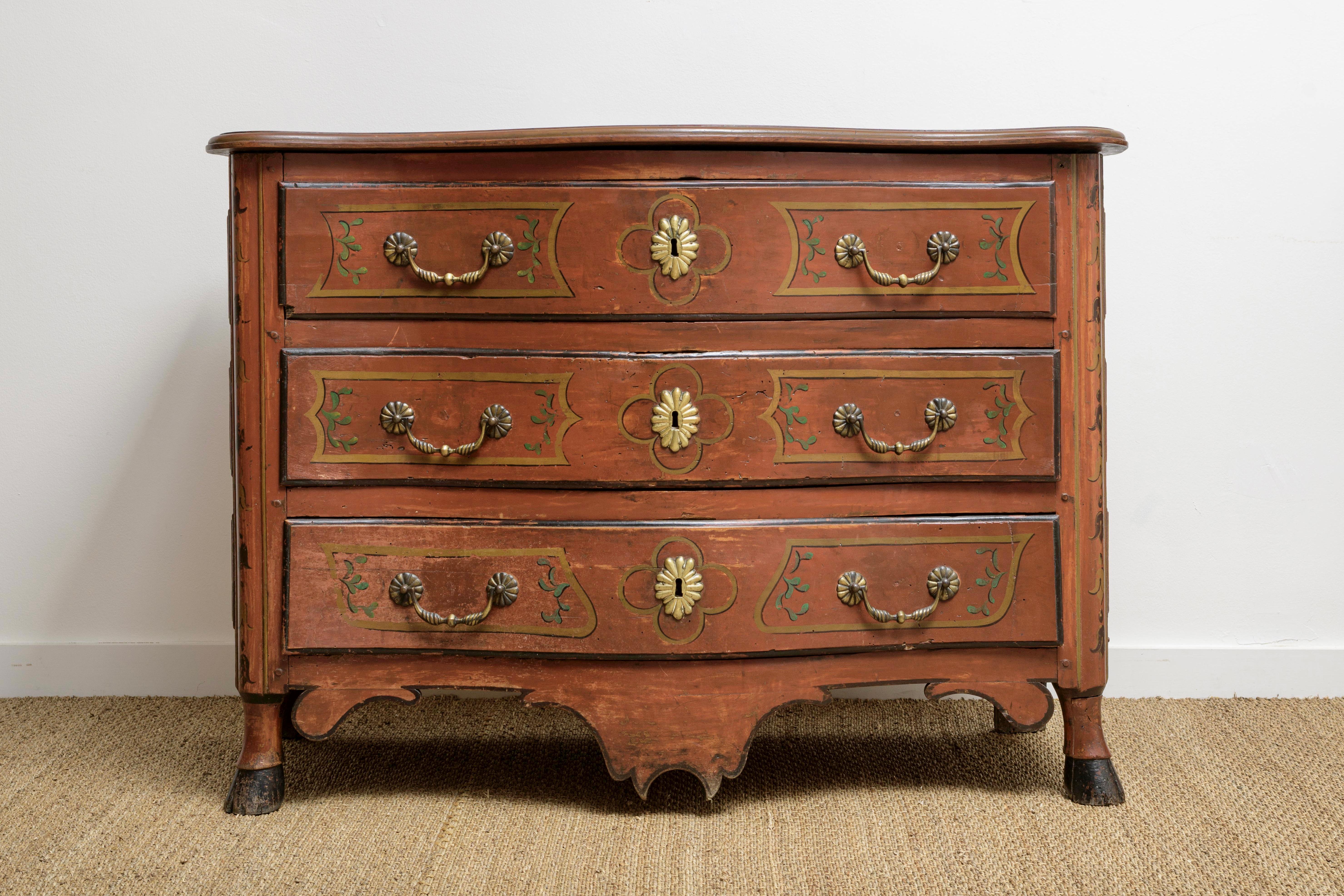 Louis XV regency period chest with original oxblood (sang de bœuf) paint  and hoof feet ca.1720.   Wonderful sides with proud flat panels decorated in same scheme. 
Wonderful color and decorative painted faux panels in gold with leaves and festoons,