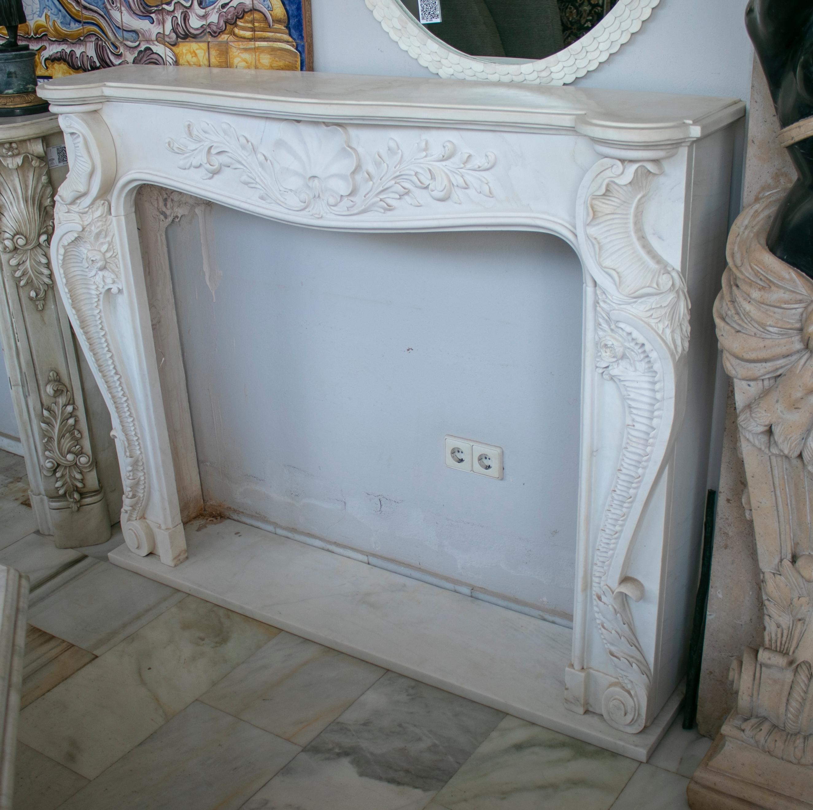 Louis XV Rococo hand carved white Carrara marble fireplace mantle.
 