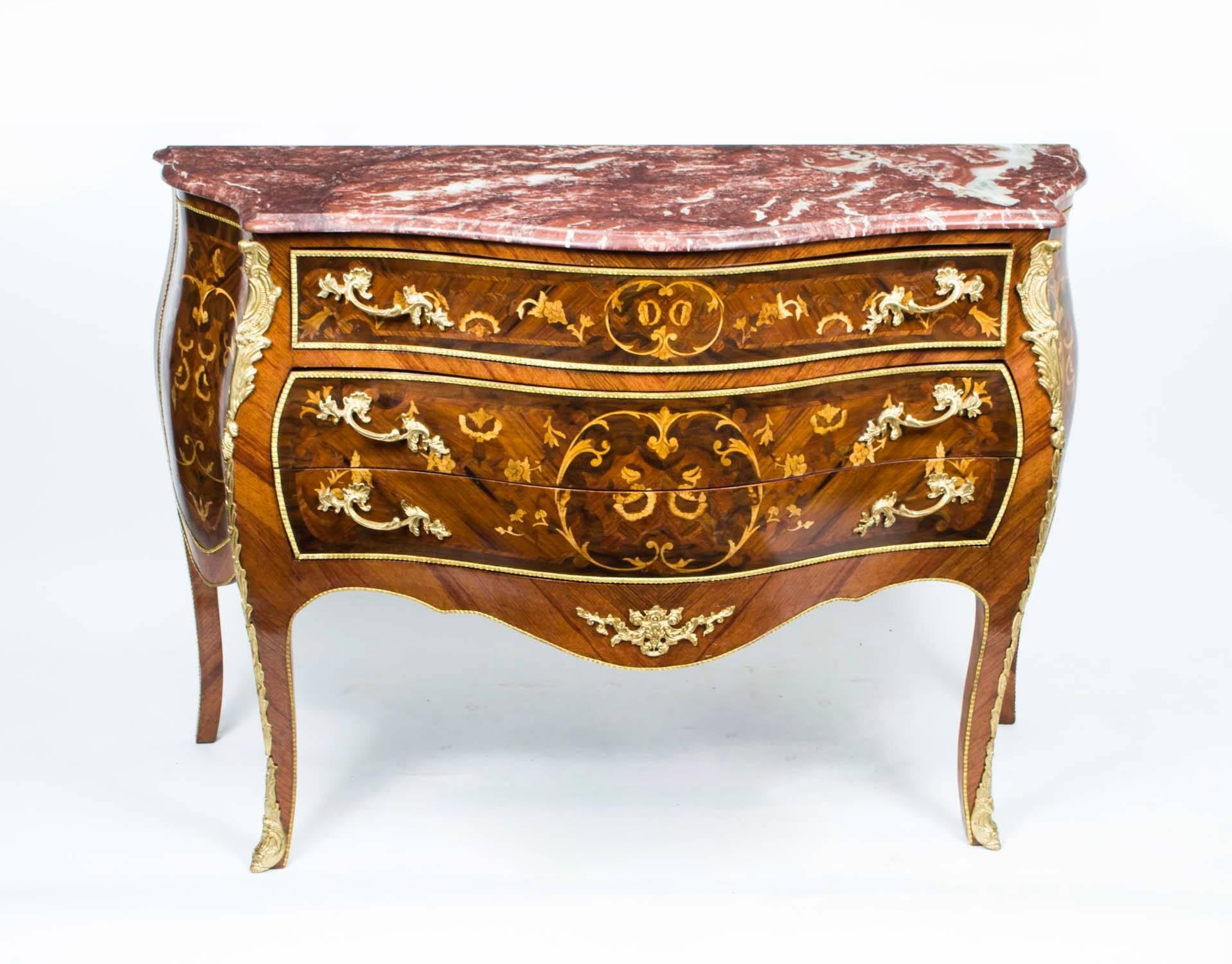 An absolutely breathtaking large French walnut commode with exquisite marquetry decoration, ormolu mounts, and a fabulous Griotte marble top, in the Louis XV style, dating from the last quarter of the 20th century.

Add a touch of supreme grandeur