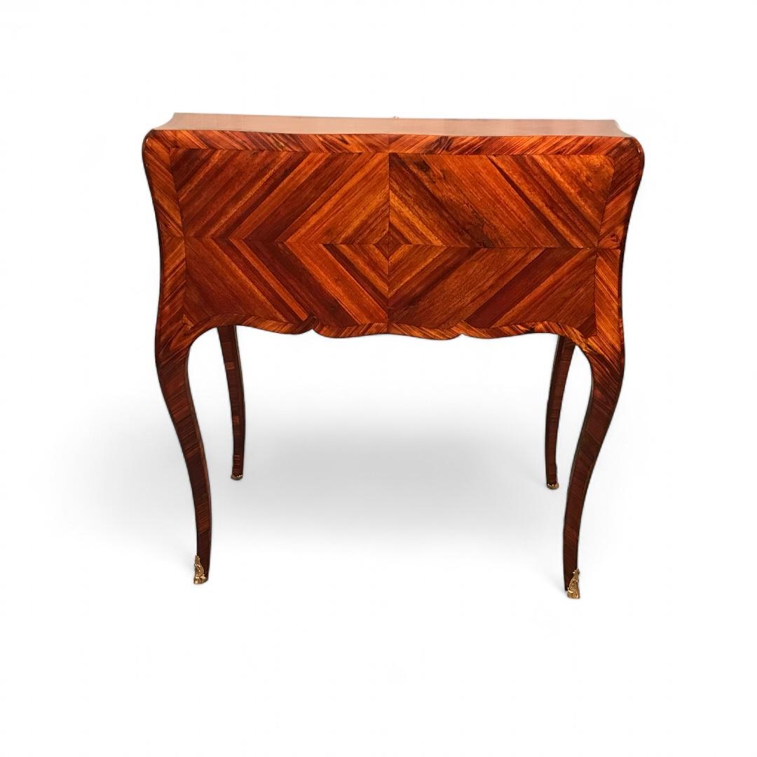 Exquisite 18th-Century Louis XV Secretary Desk
This stunning Louis XV Secretary Desk, dating back to 1770, showcases the elegance of 18th-century French craftsmanship. It features a striking rosewood veneer and intricate marquetry pattern on the