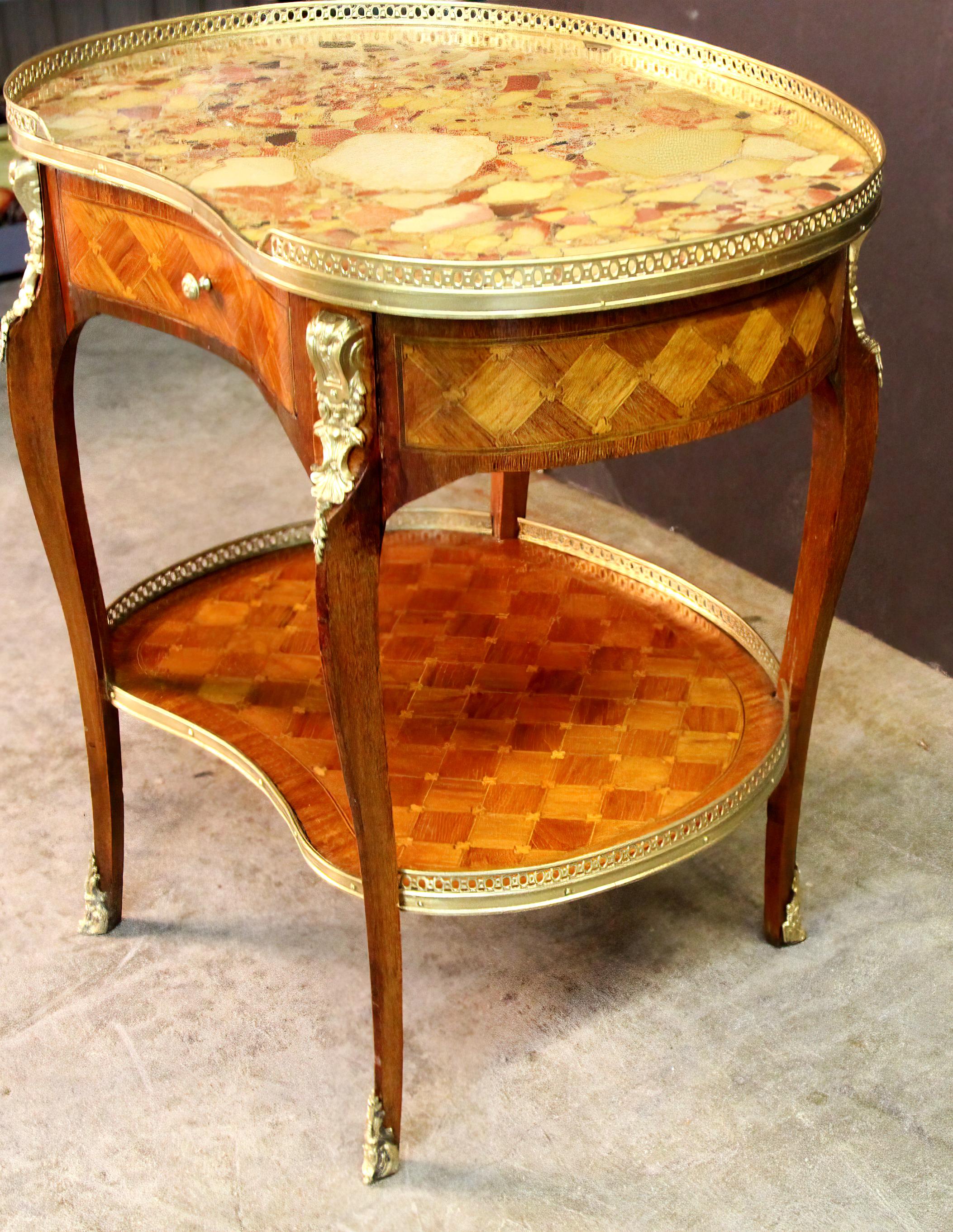 A fine French Louis XV/XVI Transitional kidney shaped kingwood parquetry inlaid side table with a pierced bronze gallery, Breche D 'Alep marble top, single drawer finely chased bronze mounts, a shaped lower lattice inlaid shelf stretcher and bronze
