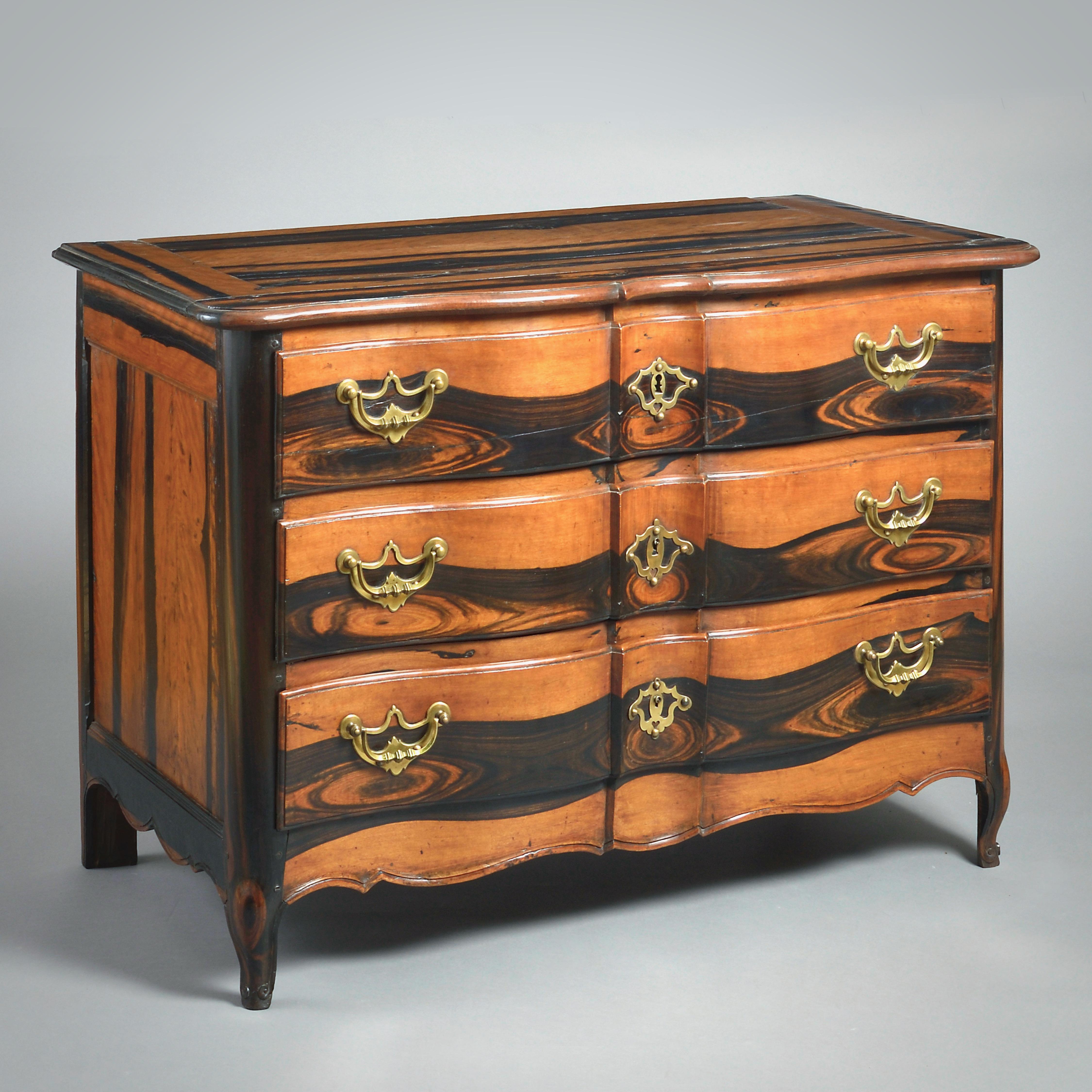 A LOUIS XV SOLID EBONY COMMODE OF ARC-EN-ARBALÈTE OUTLINE, PROBABLY BORDEAUX, CIRCA 1750.

Fitted with three drawers with pierced brass handles and escutcheons.