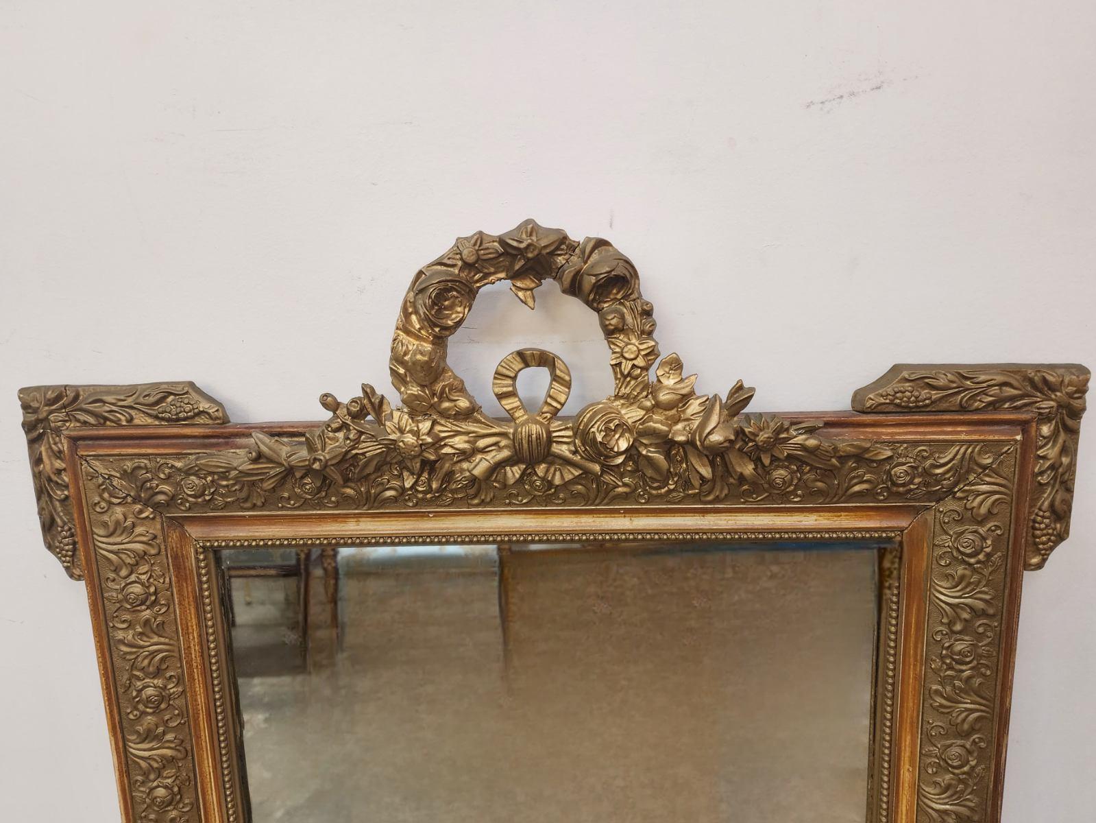 This French Louis XV style gold gilt and painted framed mirror showcases intricate details and ornate design elements characteristic of the period. The delicate gold gilt accents and painted motifs on the frame capture the opulence and elegance of