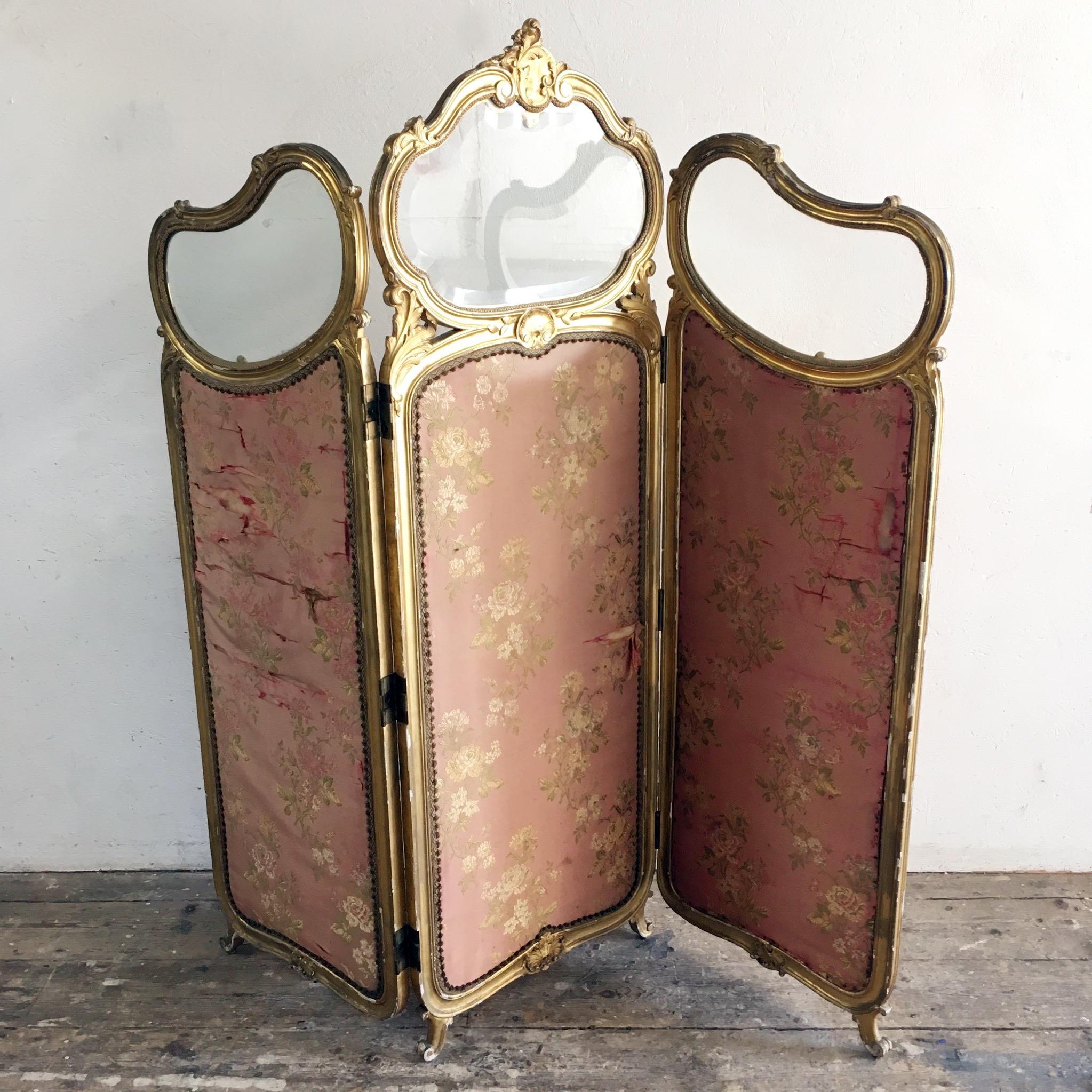 This 19th century antique Louis XV style French dressing screen 

The screen is 3 hinged panels 

This is a short height screen, maybe originally for a child

Original ornately hand carved giltwood frame

High quality hand beveled original