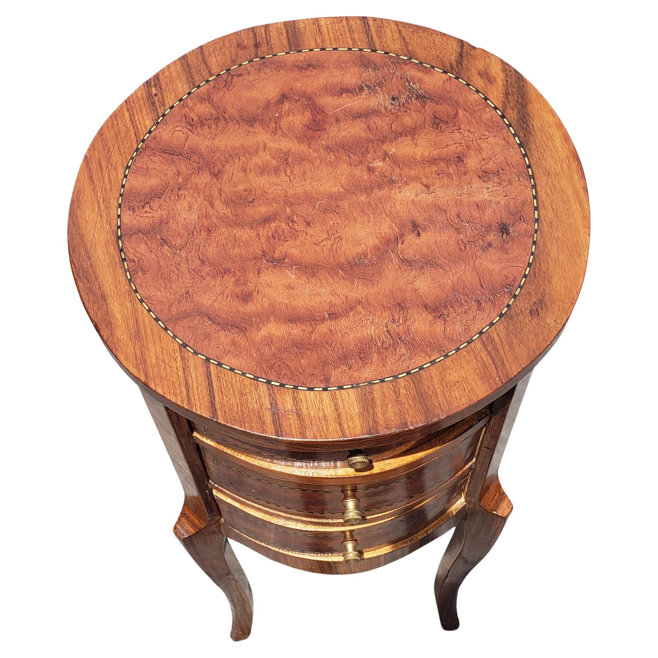 Louis XV style three drawer satinwood inlaid mixed banded fruitwood round side table in good vintage condition. Circa 1950s. Measures 13.5 inches in diameter and stands 30.75 inches tall. All three drawers opening and closing smoothly. Excellent as
