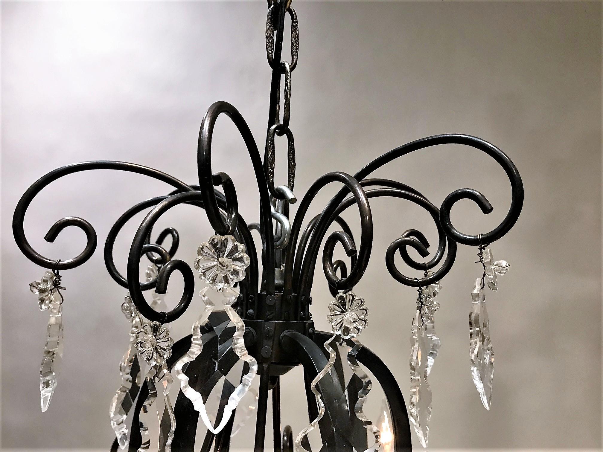 This handsome Louis XV style chandelier was made during the Belle Epoque era somewhere in Continental Europe. Originally candle-burning, it is now wired for electricity to US standards using candelabra-base bulbs of up to 40 watts each. The frame is