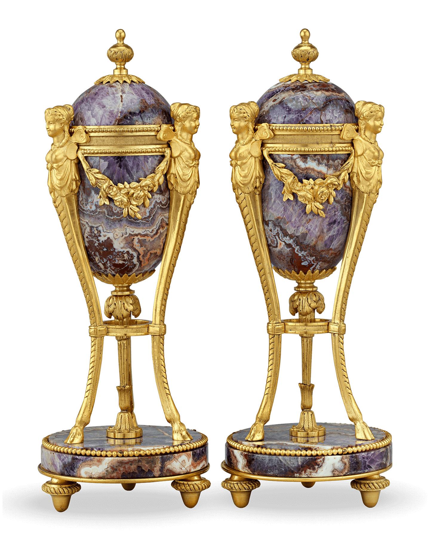 The bodies of this pair of Louis XV style cassolettes are formed from stunning examples of amethyst. Their graceful design showcases the qualities for which this gemstone is so loved, from its radiating crystalline structure to its rich shades of