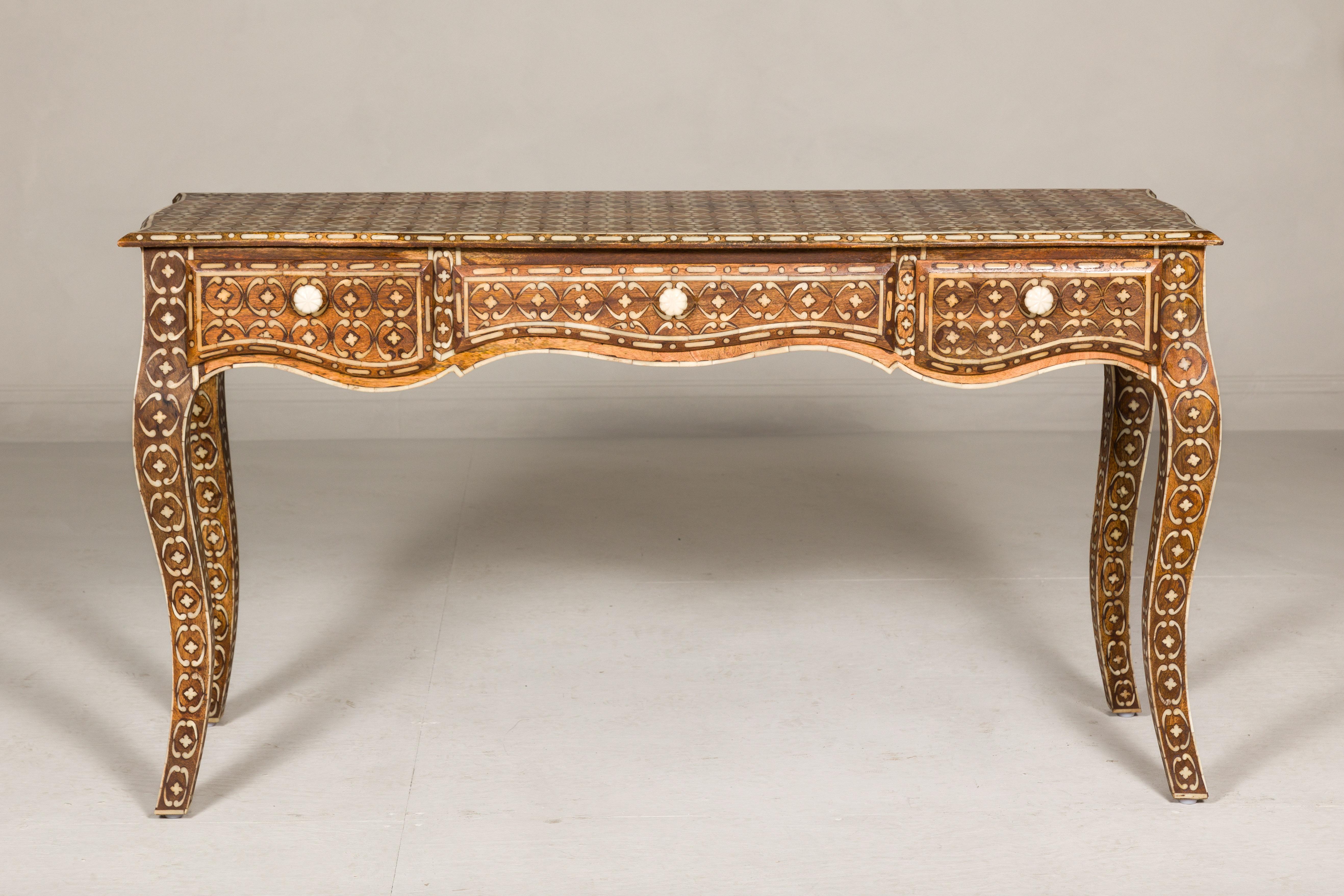 Anglo-Indian Louis XV style mango wood console table or desk with inlaid bone décor. A sublime marriage of East meets West, this Anglo-Indian Louis XV style console table or desk is an ode to opulence and artistry. Crafted from robust mango wood,